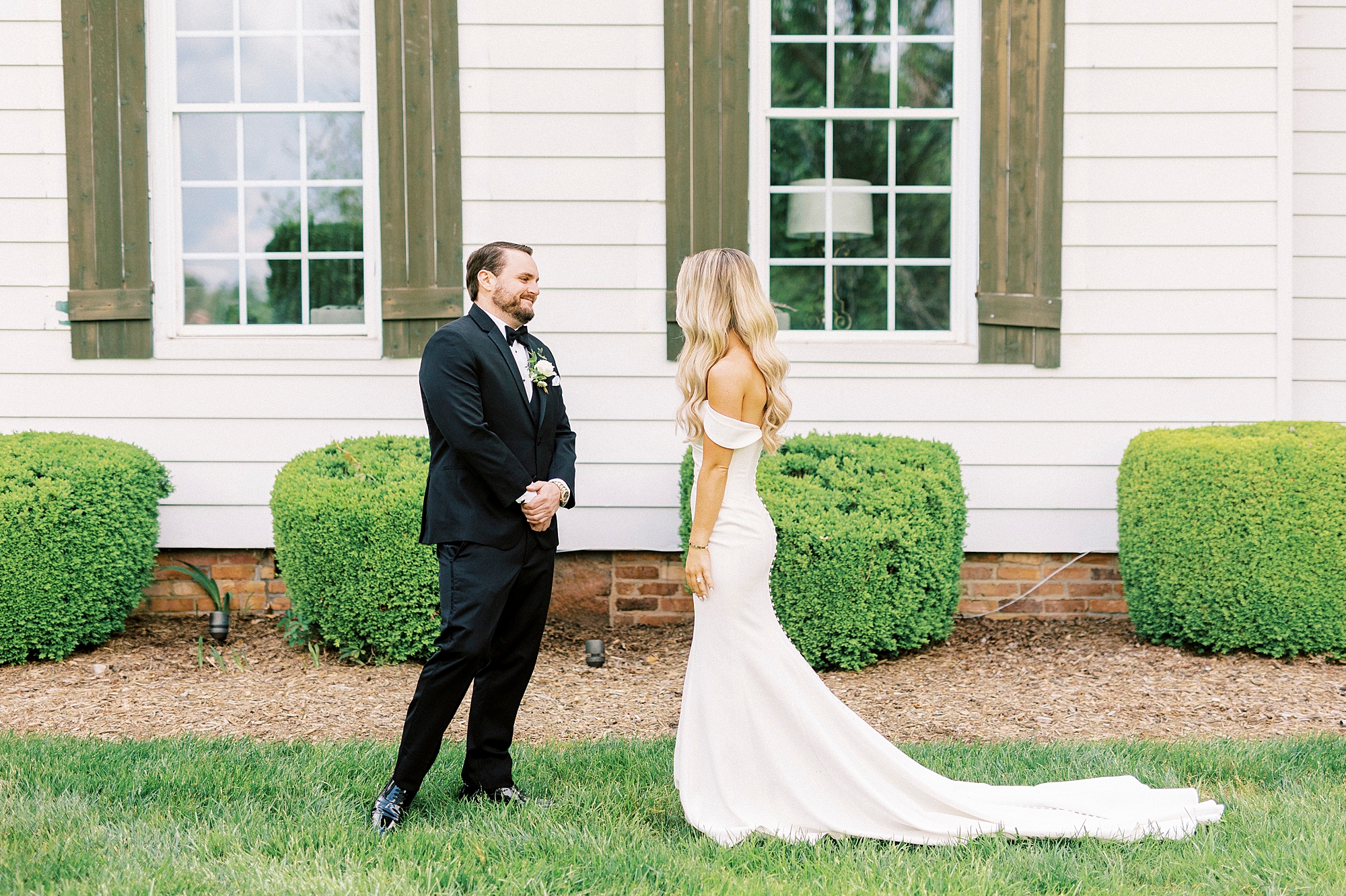 groom turns to look at bride during first look on NC wedding day