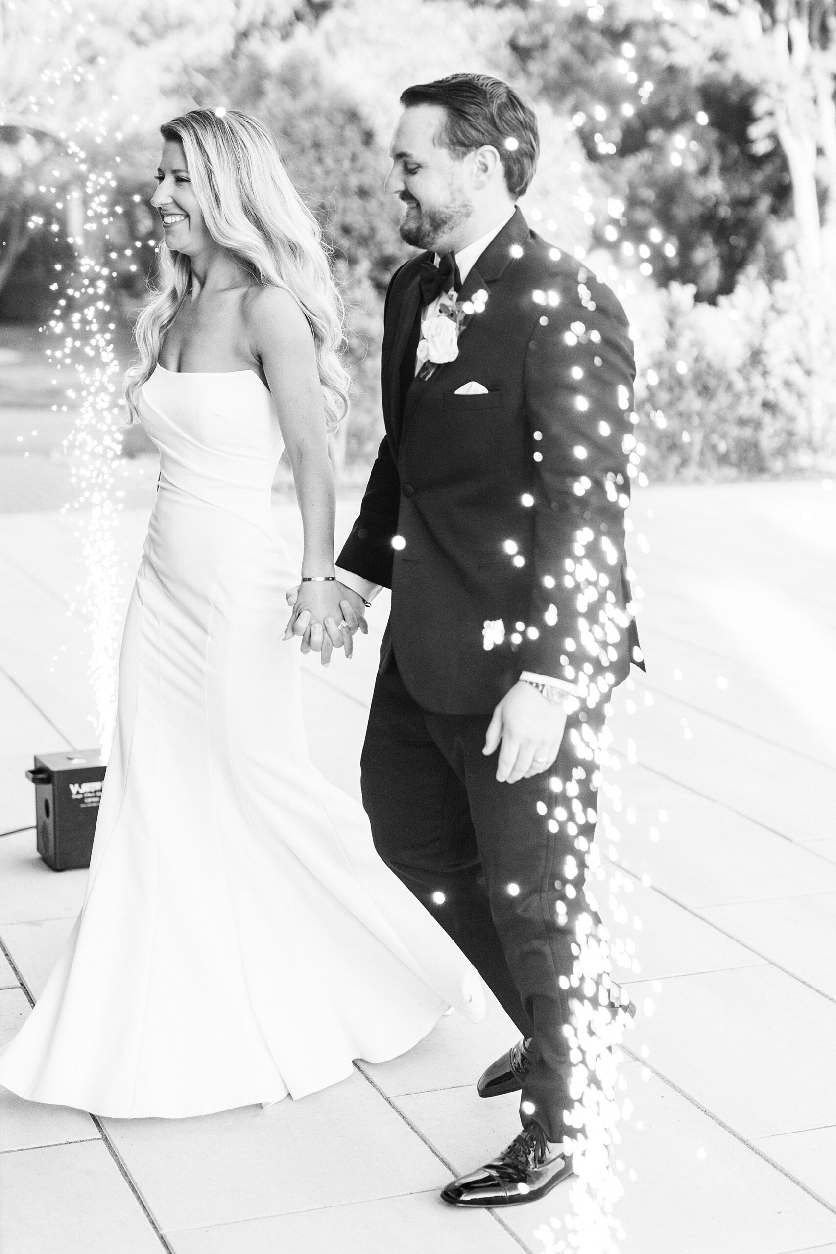 bride and groom walk into reception as sparklers go off by them