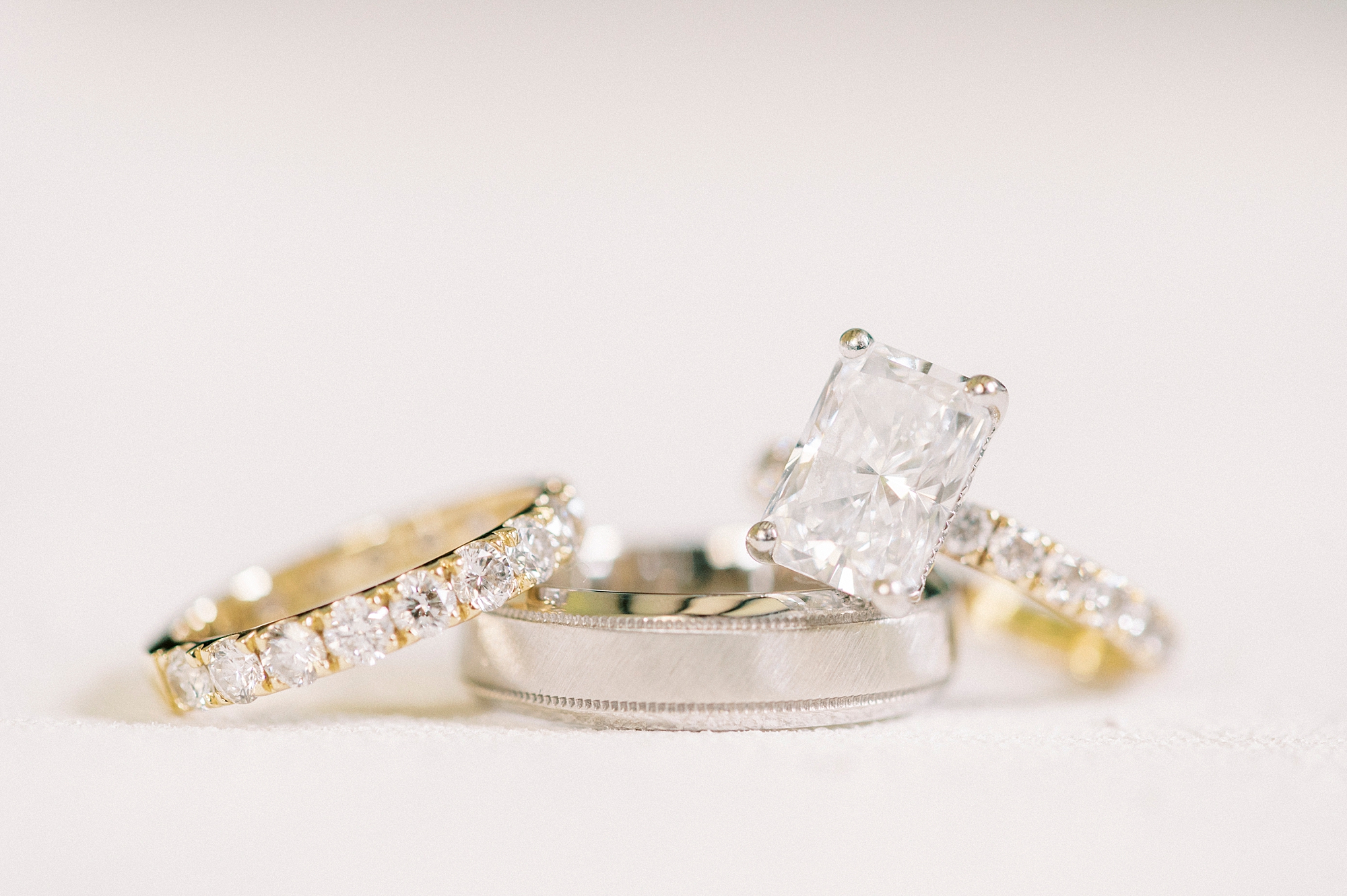 gold and diamond rings lay stacked together