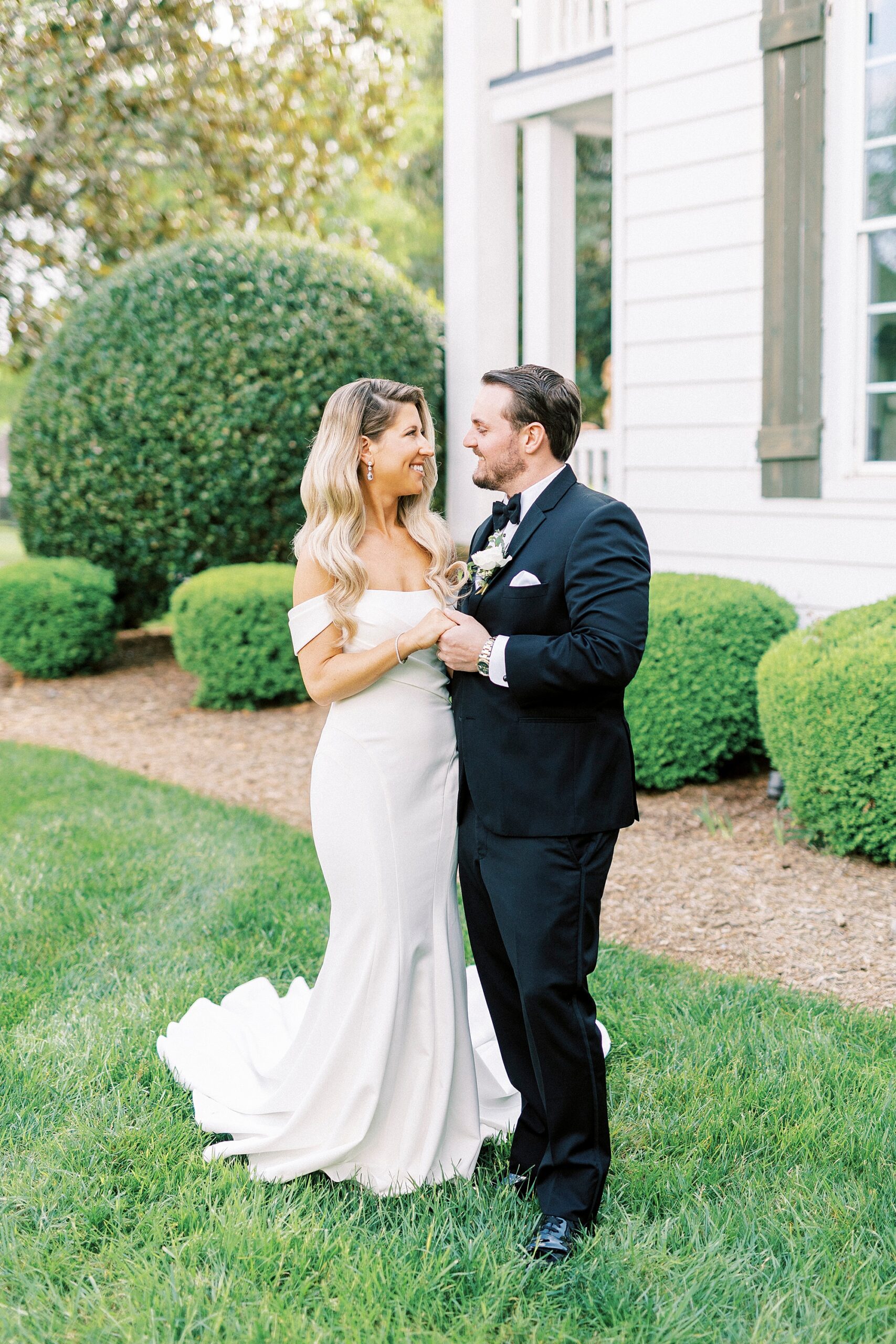 newlyweds hold hands standing outside the Venues at Langtree