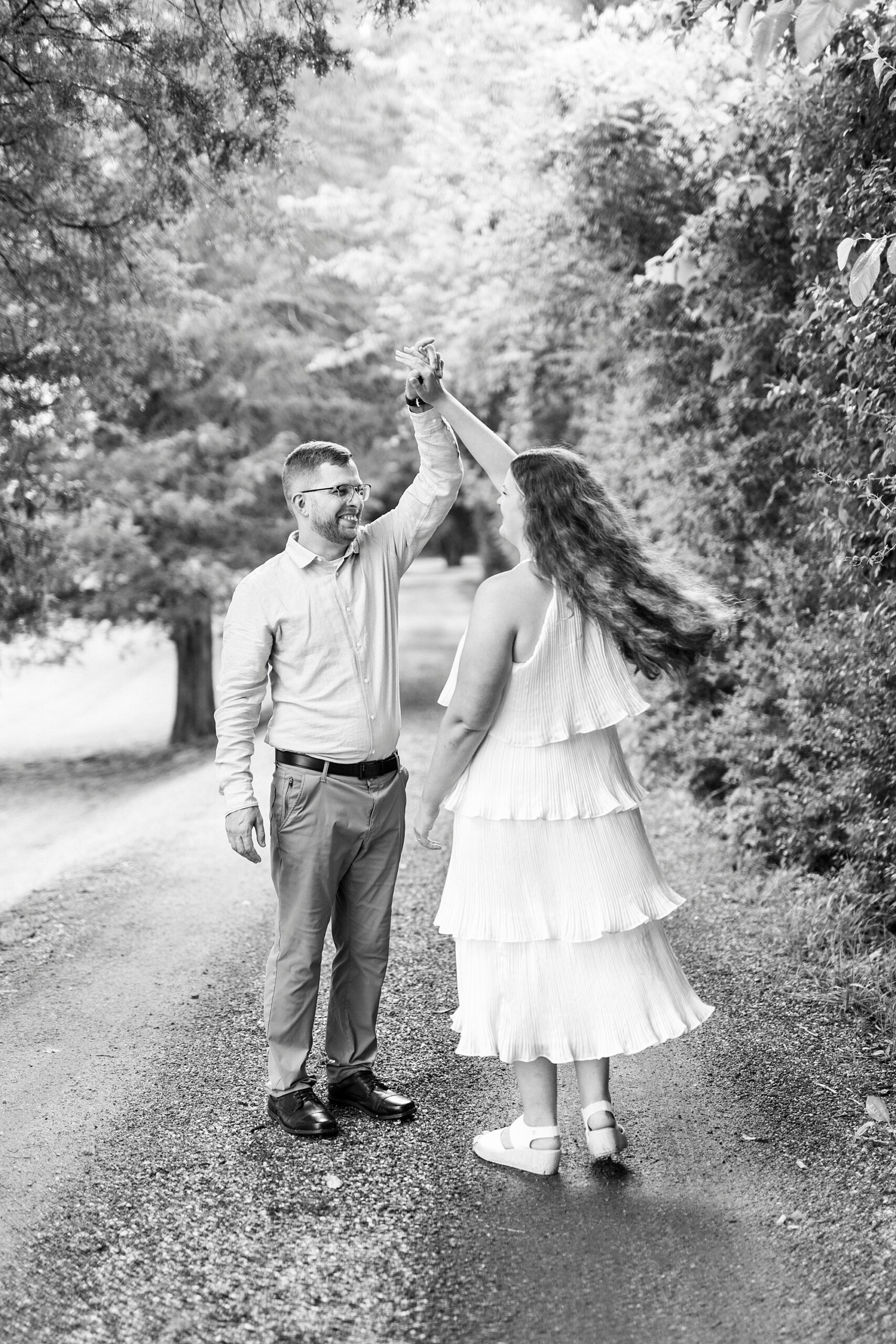 man twirls woman on walkway at Summerfield Farms