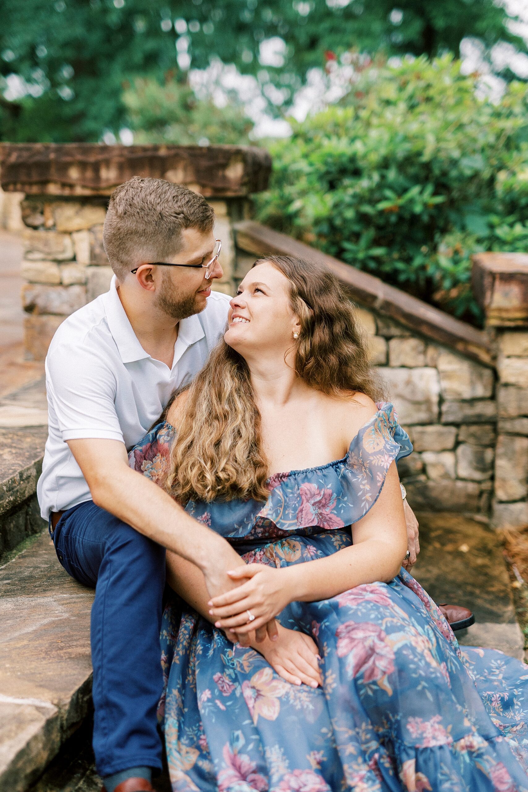 man and woman sit on steps together snuggling