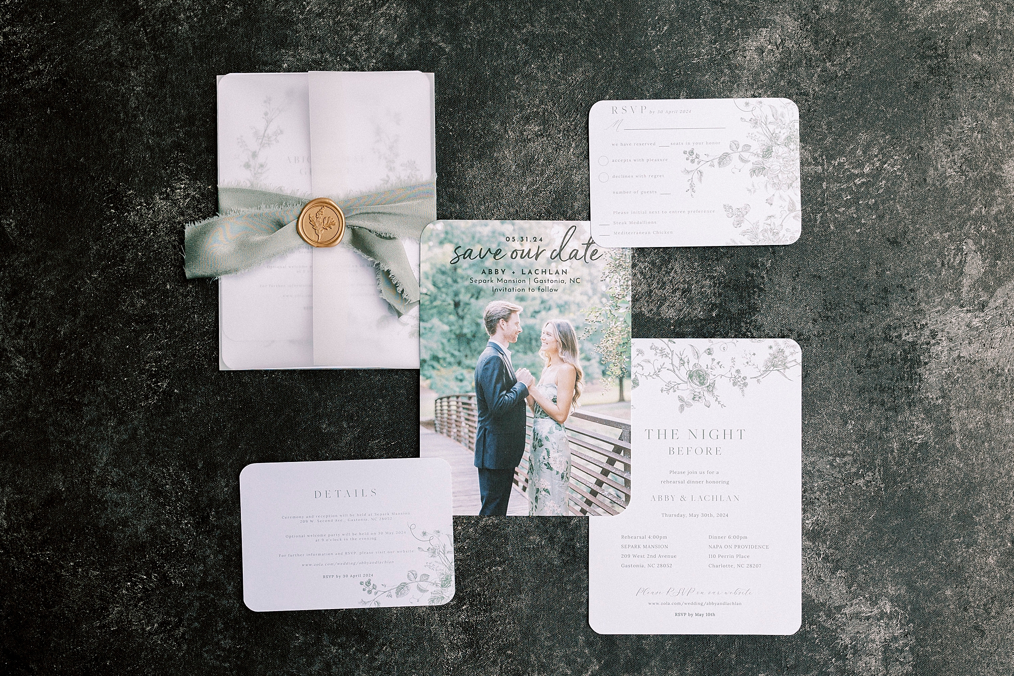 invitation suite with green floral accents and gold wax seal