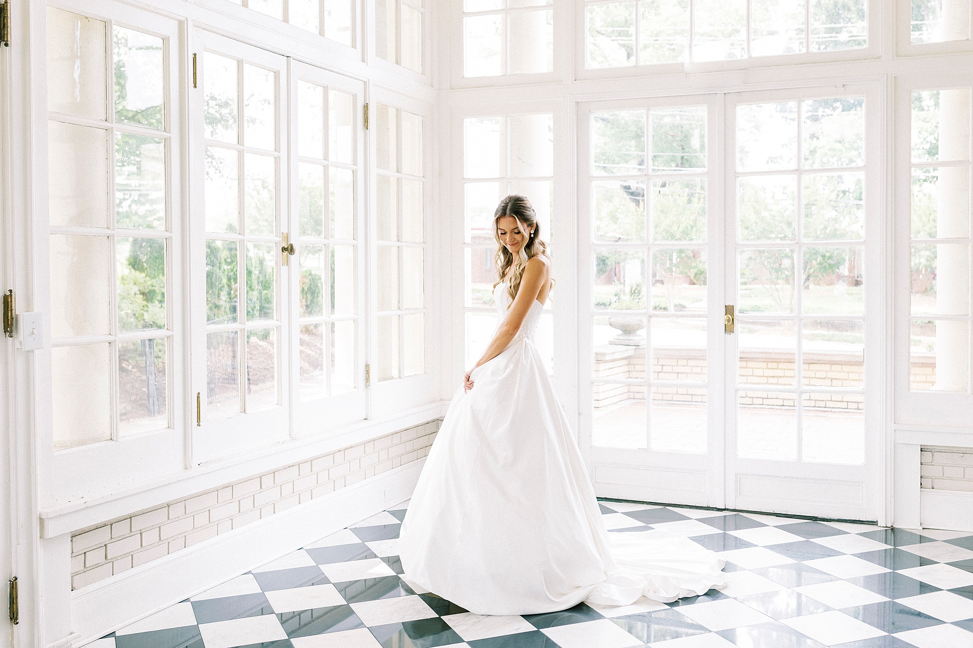 bride twirls in wedding dress in sunroom at Separk Mansion