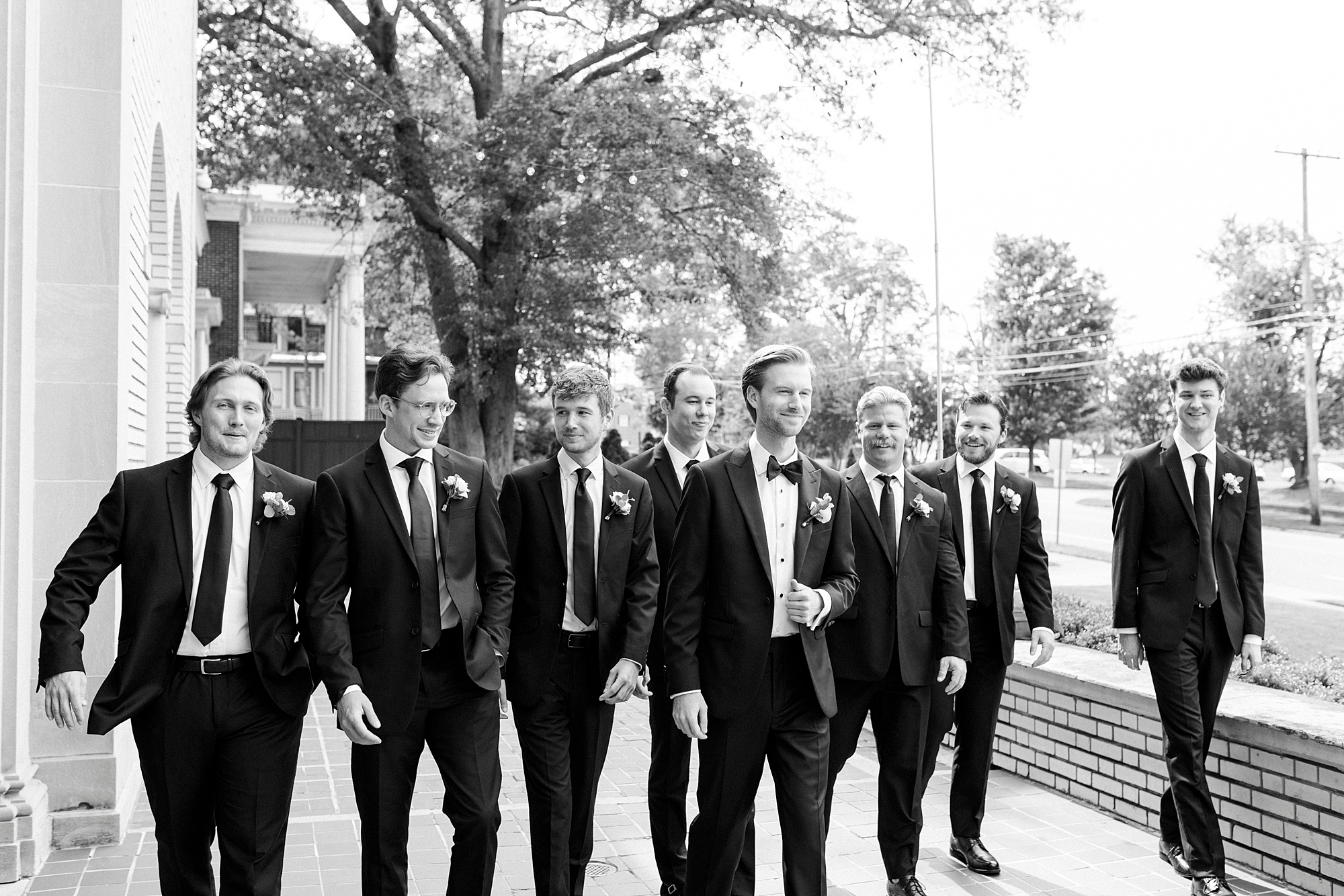 groom and groomsmen walk on patio at Separk Mansion