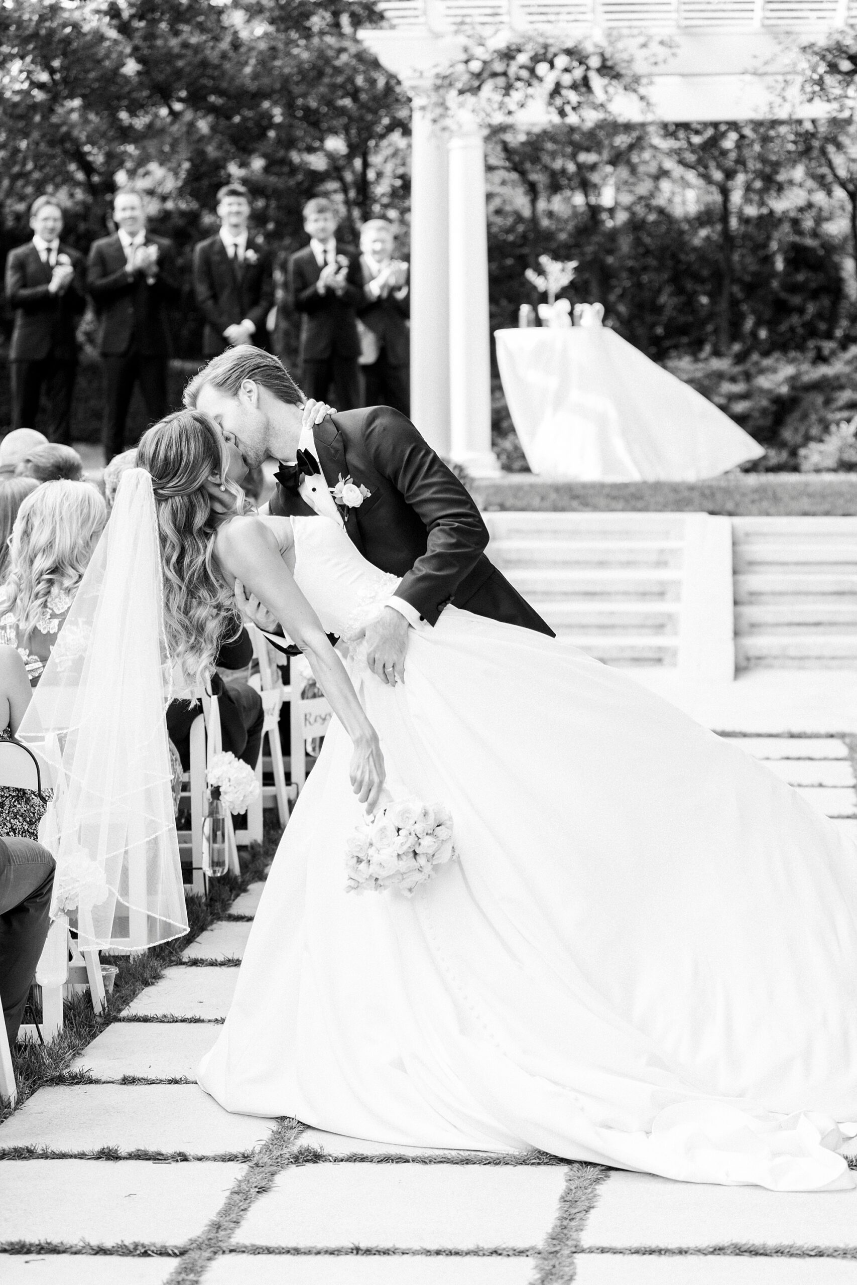groom kisses bride dipping her in garden at Separk Mansion