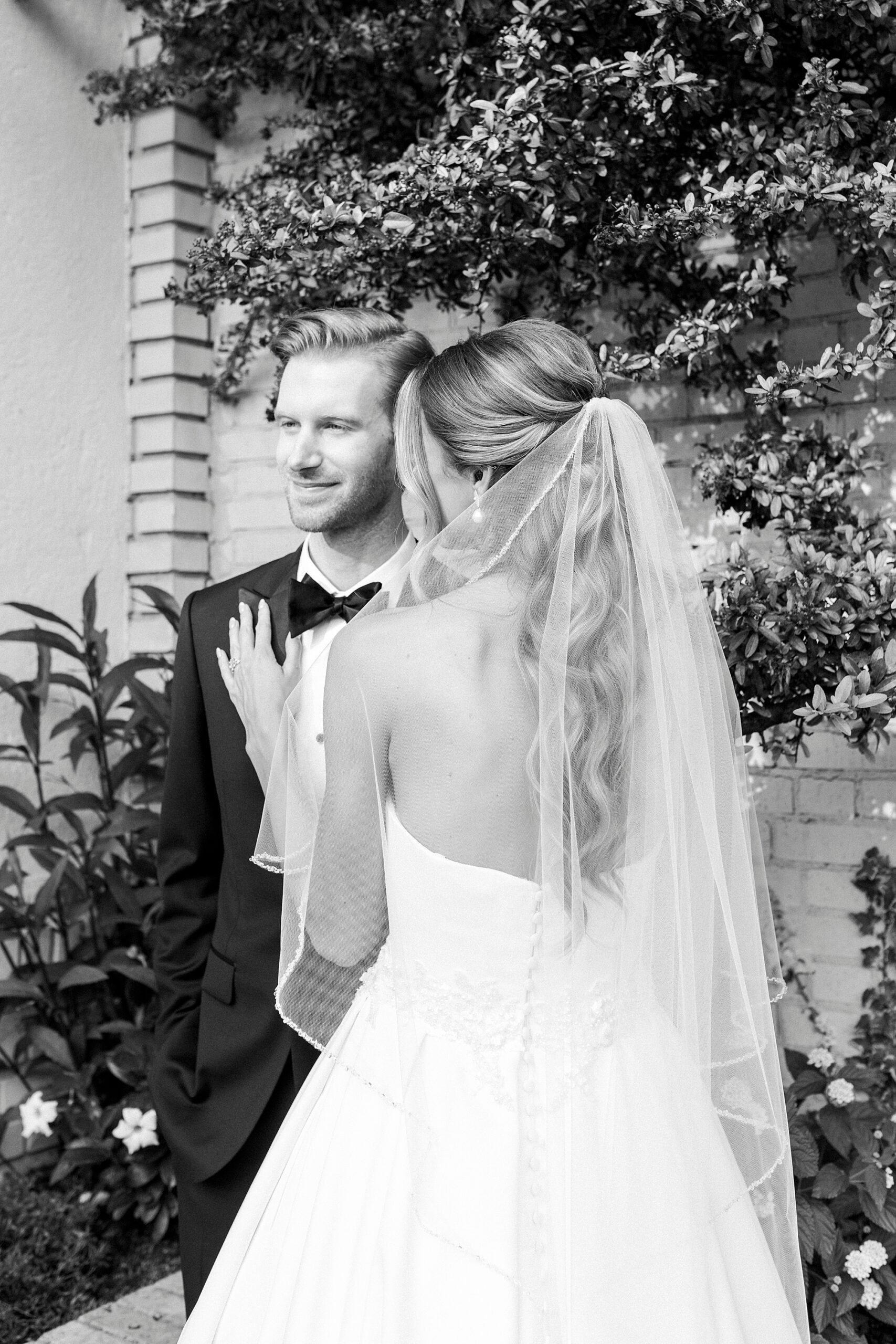 bride holds groom's suit lapel