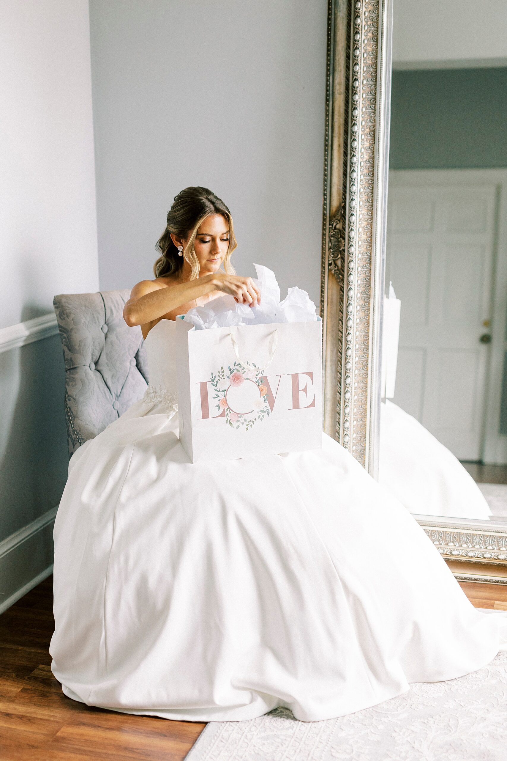 bride opens gift inside bridal suite at Separk Mansion