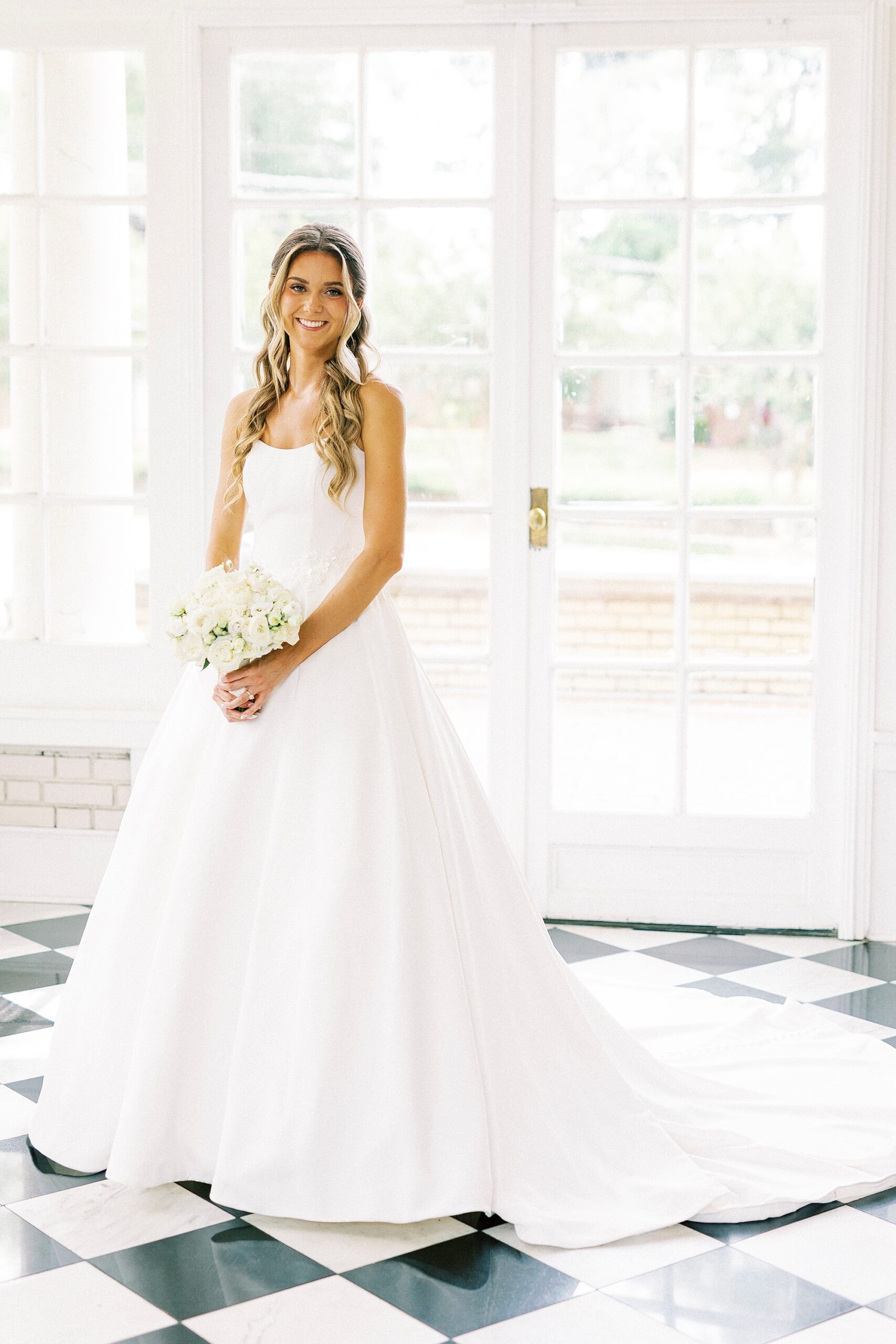 bride holds bouquet of white flowers for spring wedding
