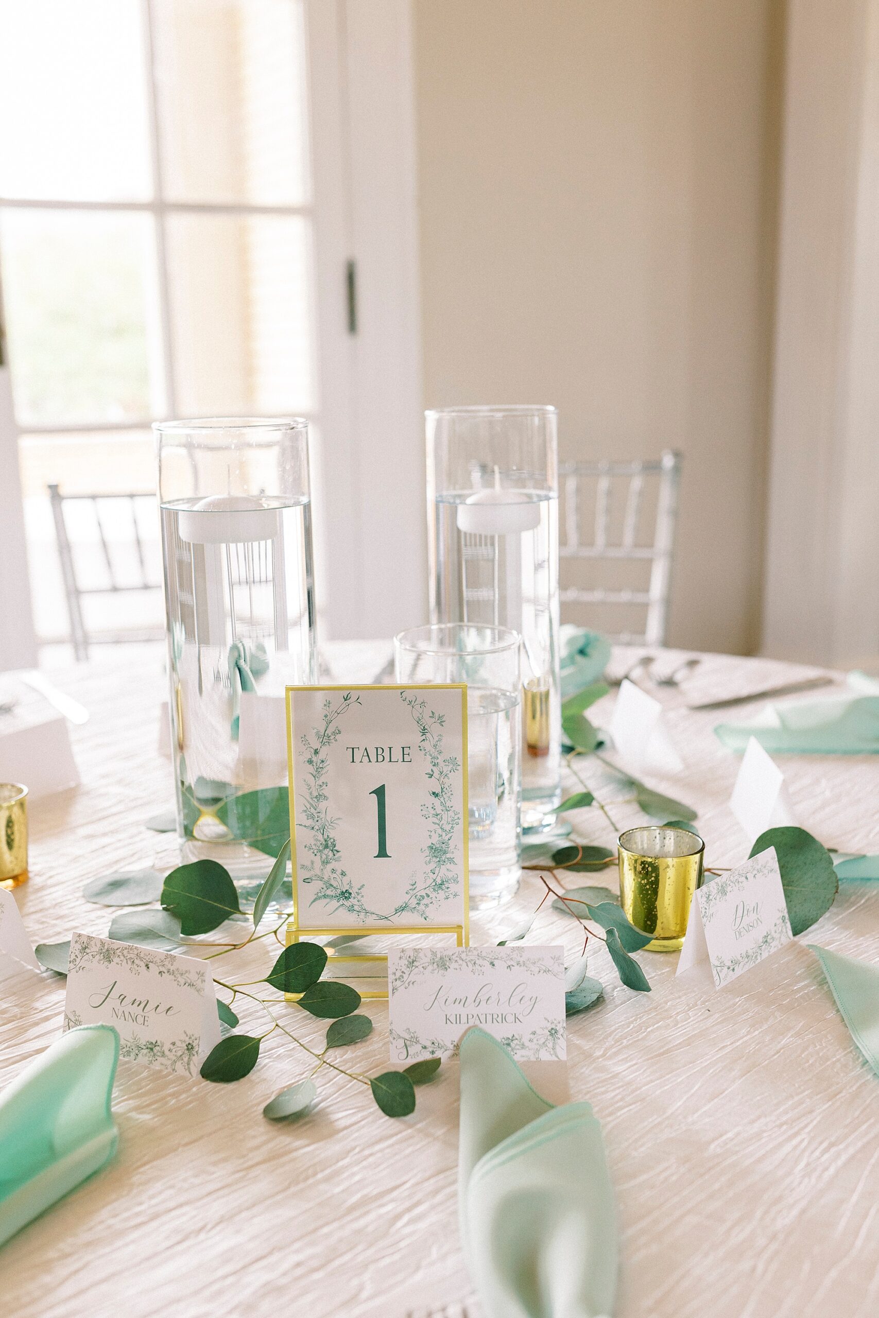 spring wedding reception with mint green napkins and white and green table numbers