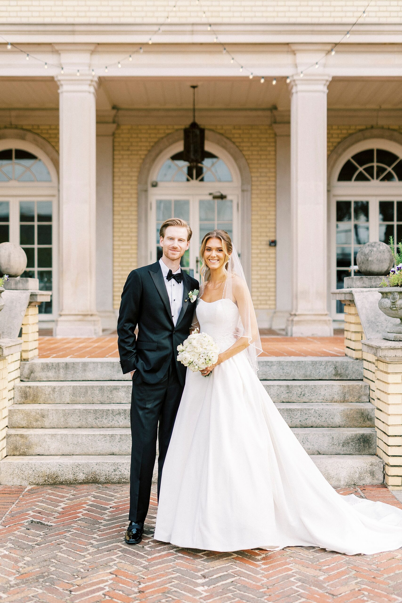 bride and groom stand by stone steps at Separk Mansion