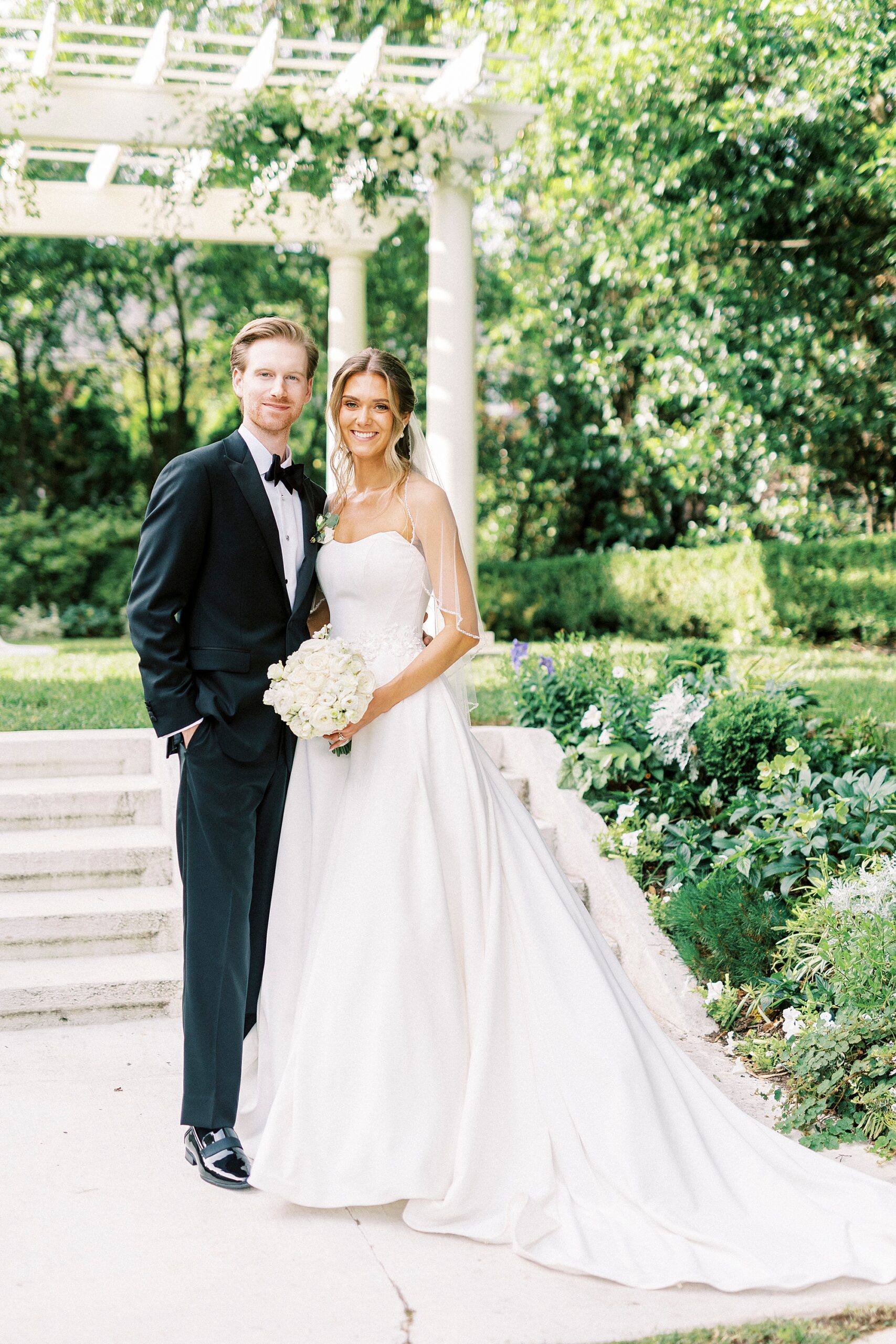 newlyweds pose by stone arbor in garden of Separk Mansion