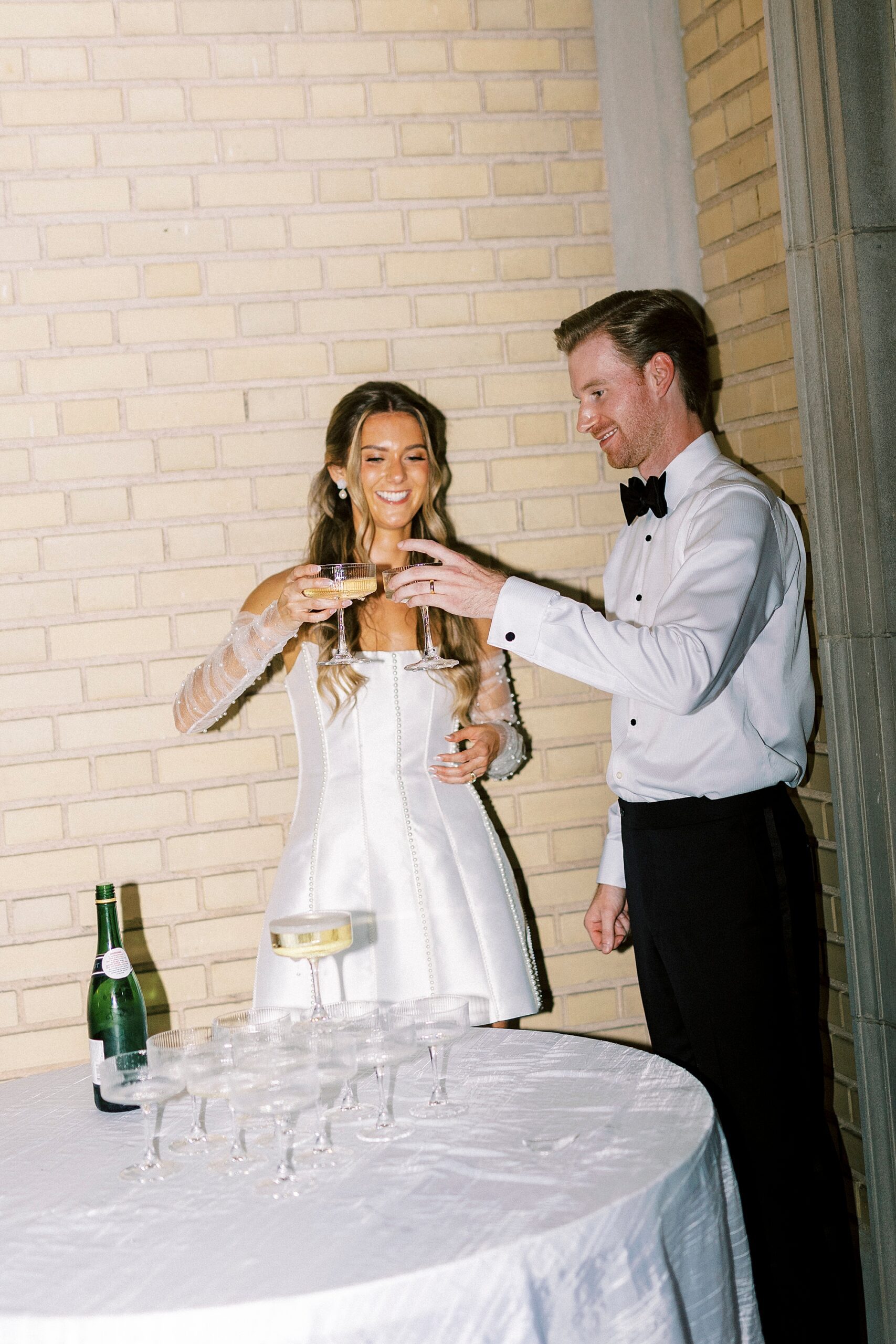 bride and groom toast champagne glass by tower