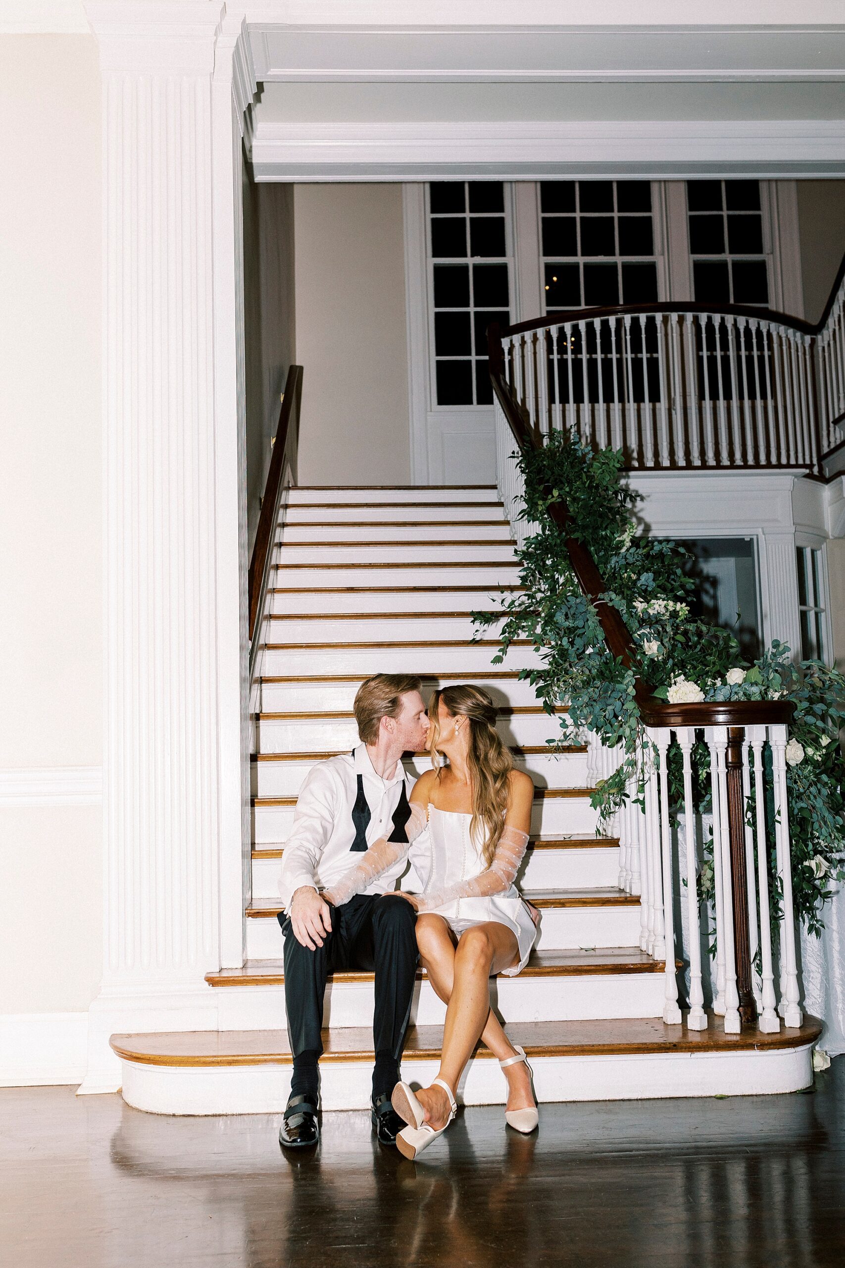 newlyweds kiss on staircase inside Separk Mansion