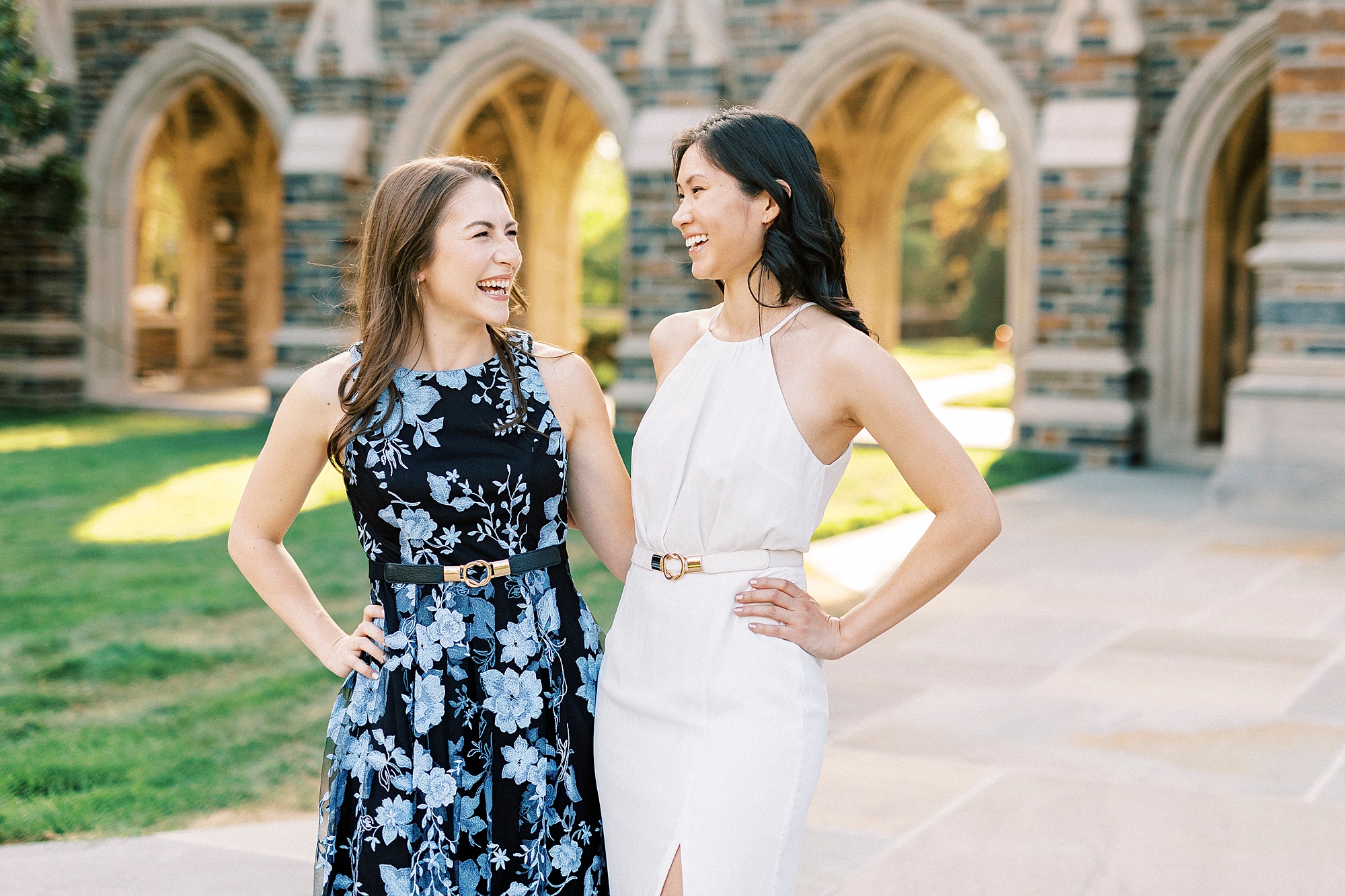 two friends smile hugging in front of chapel at Duke University