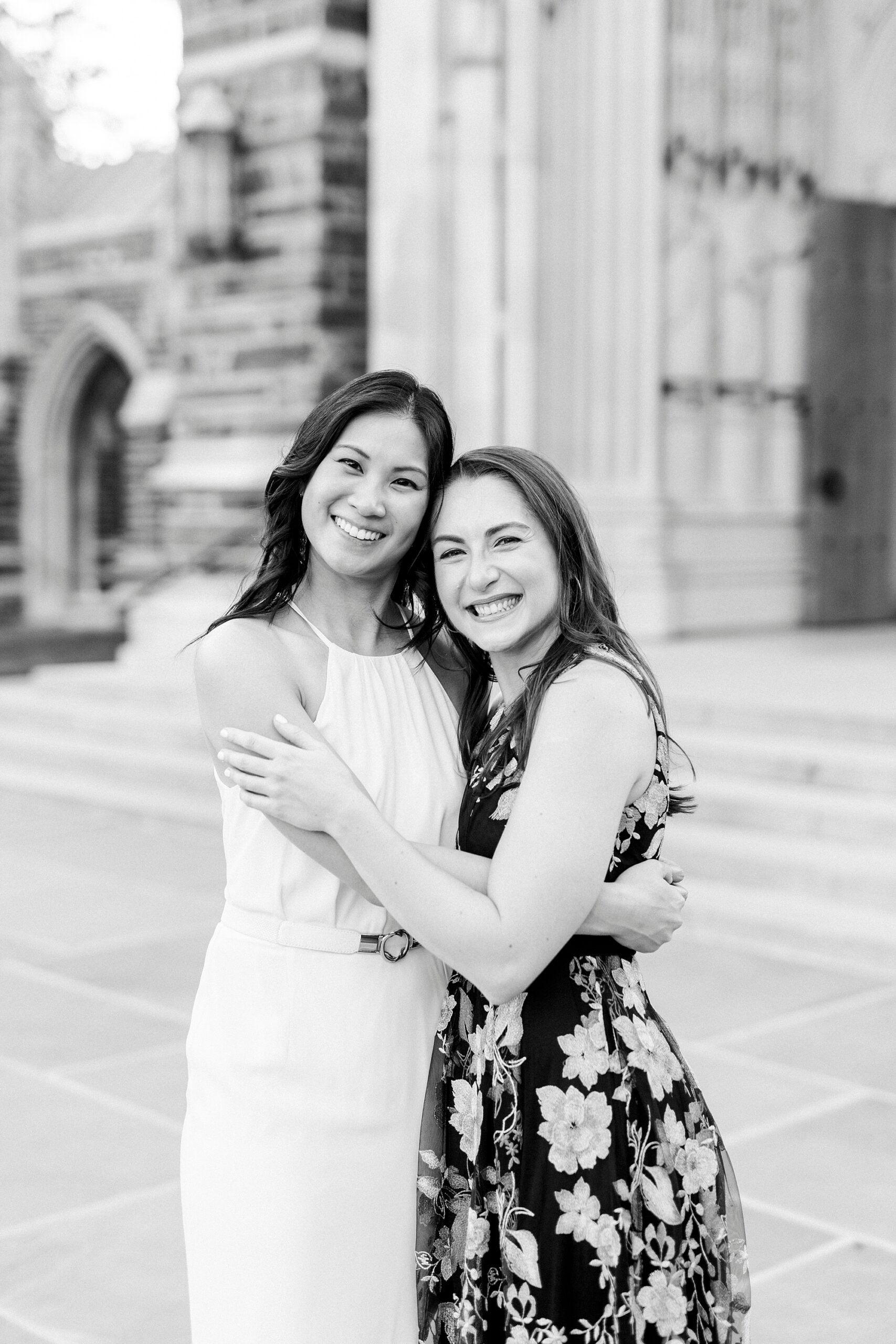 two graduates hug outside chapel in North Carolina