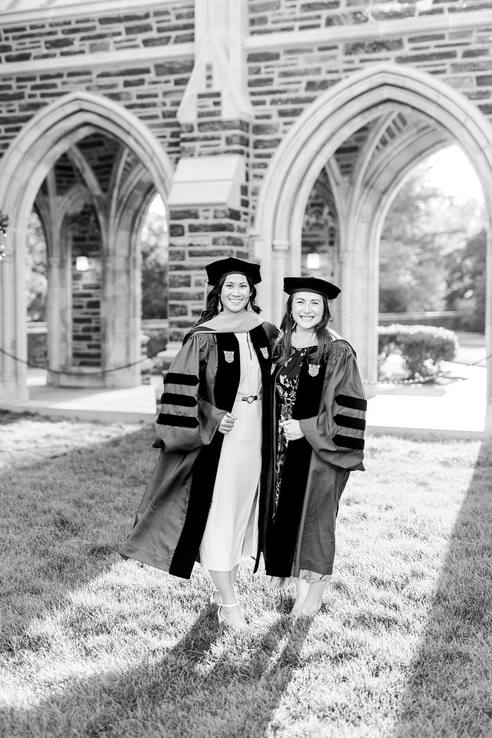 two women wear doctorate hat and robe at Duke University
