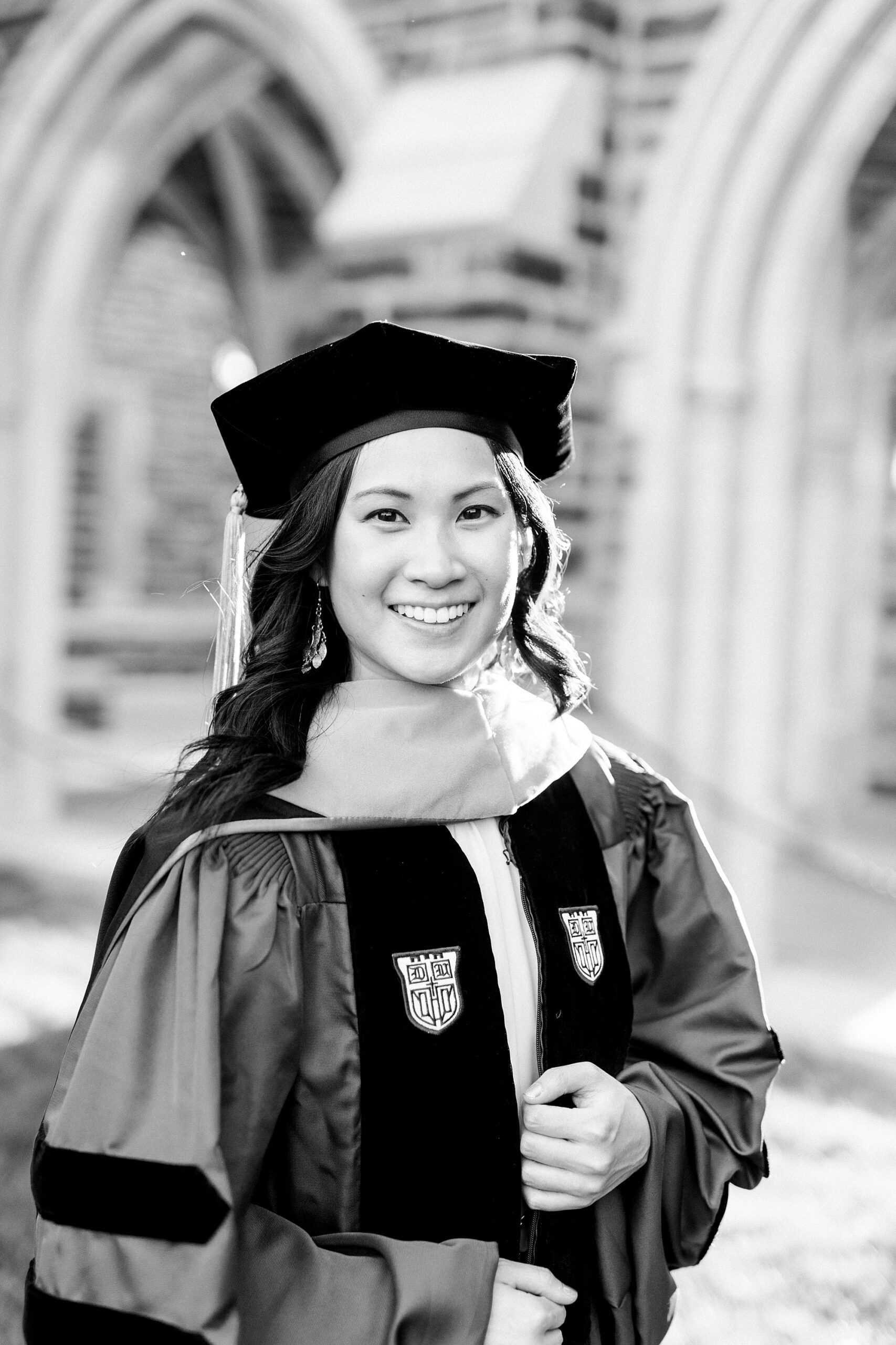 woman poses in doctorate robe during Duke University graduation portraits