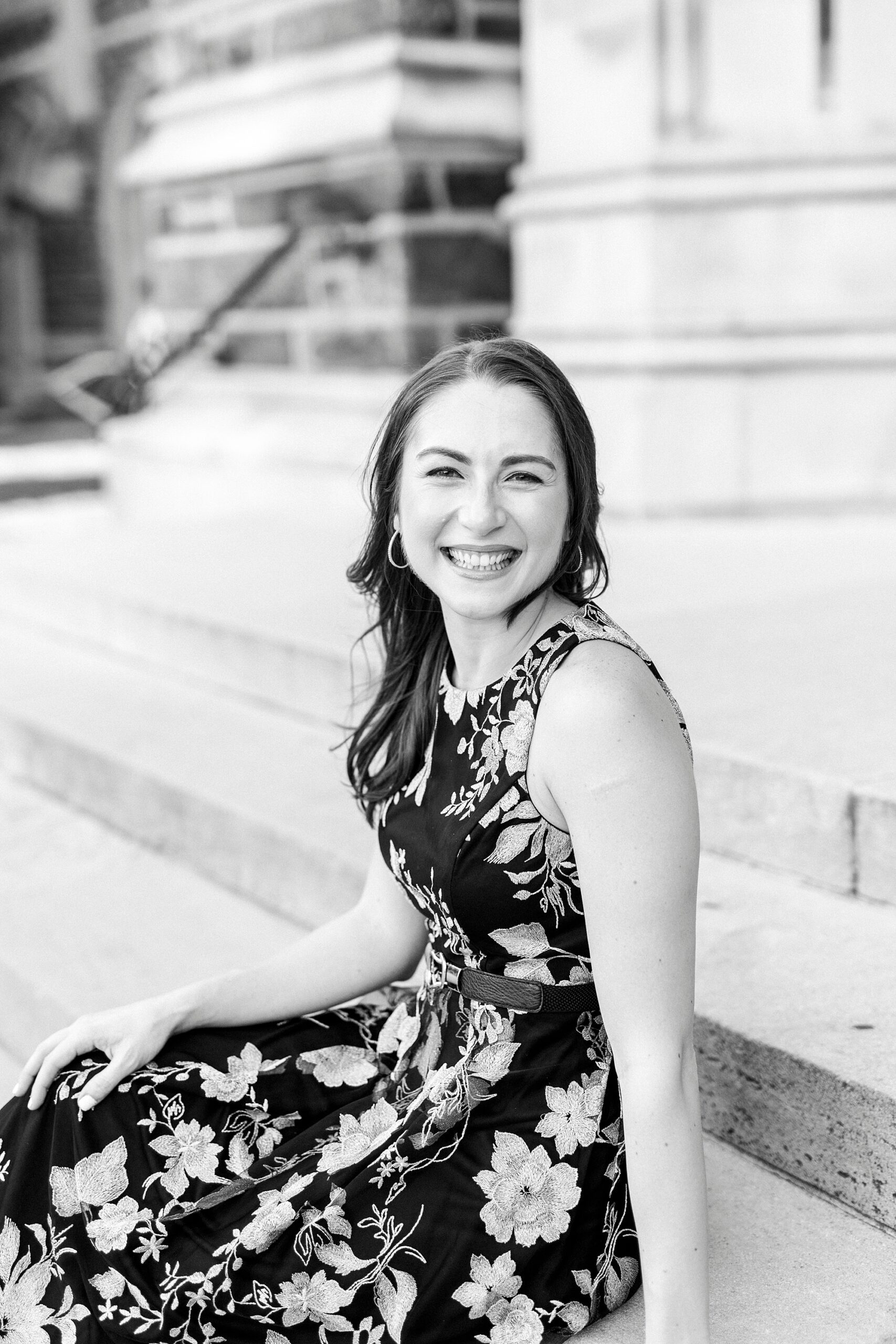 woman smiles sitting on steps of chapel at Duke University