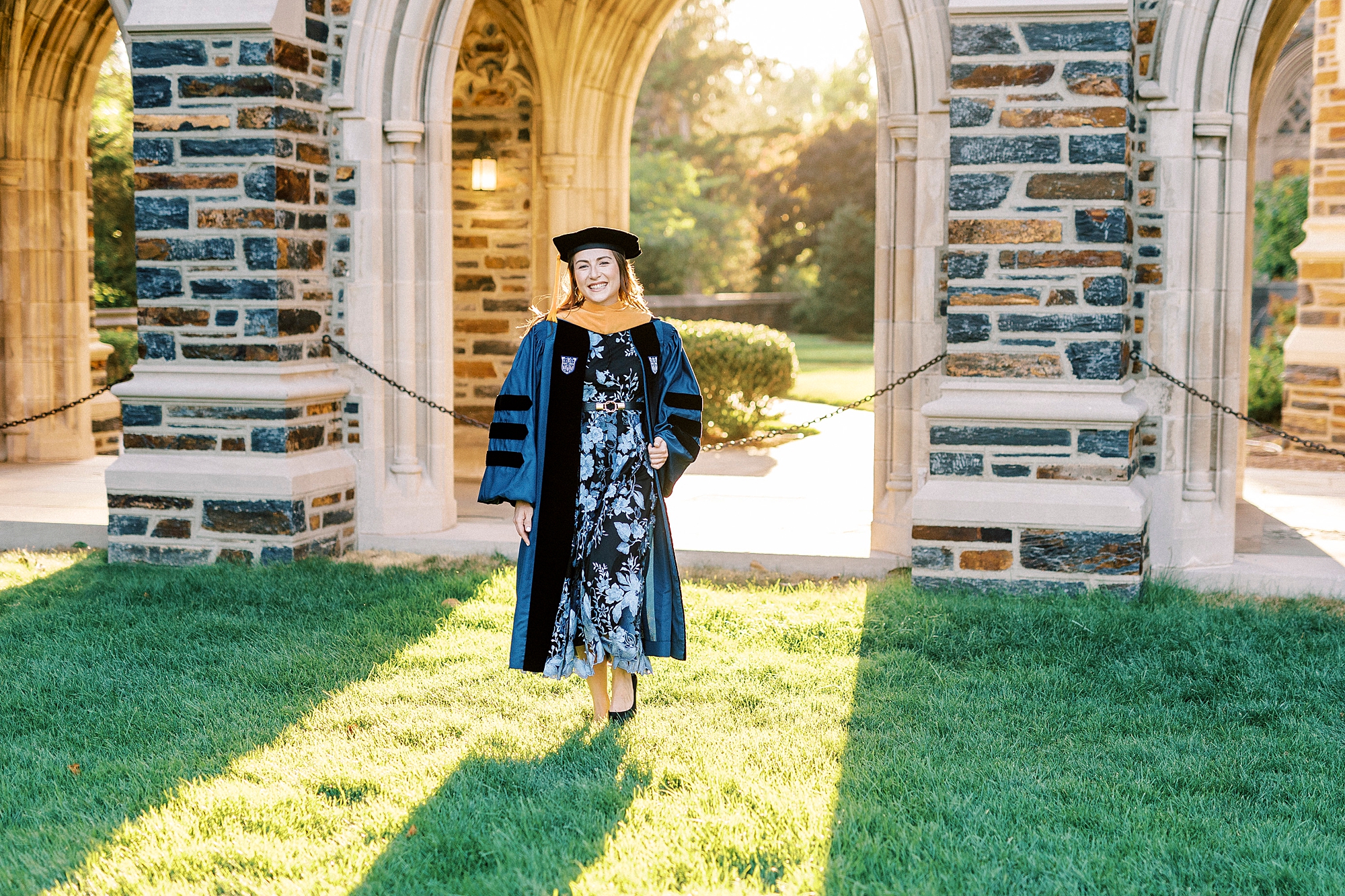 woman walks on grass at chapel at Duke University