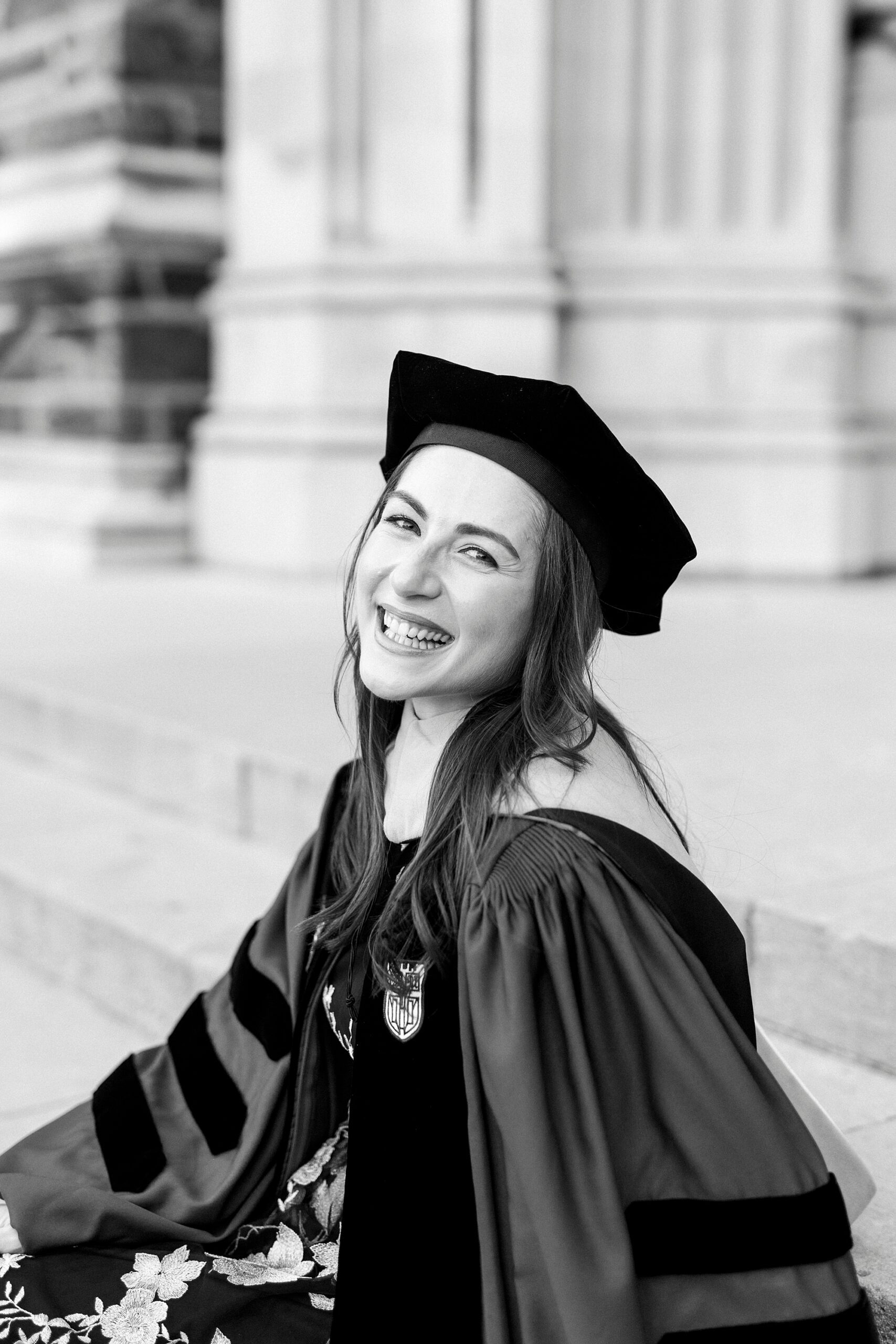 woman laughs sitting on steps of chapel at Duke University