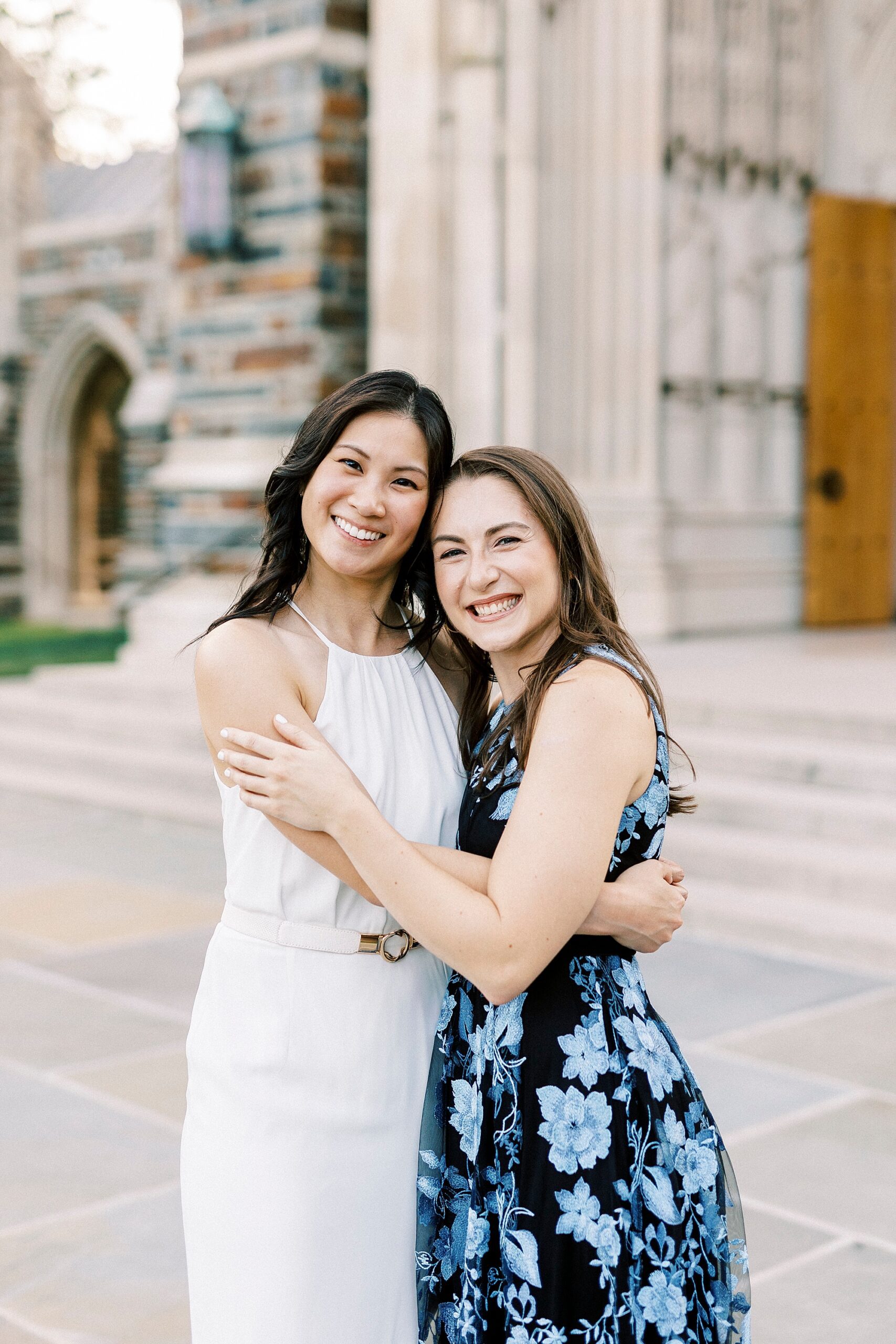 two friends hug during graduation portraits at Duke University