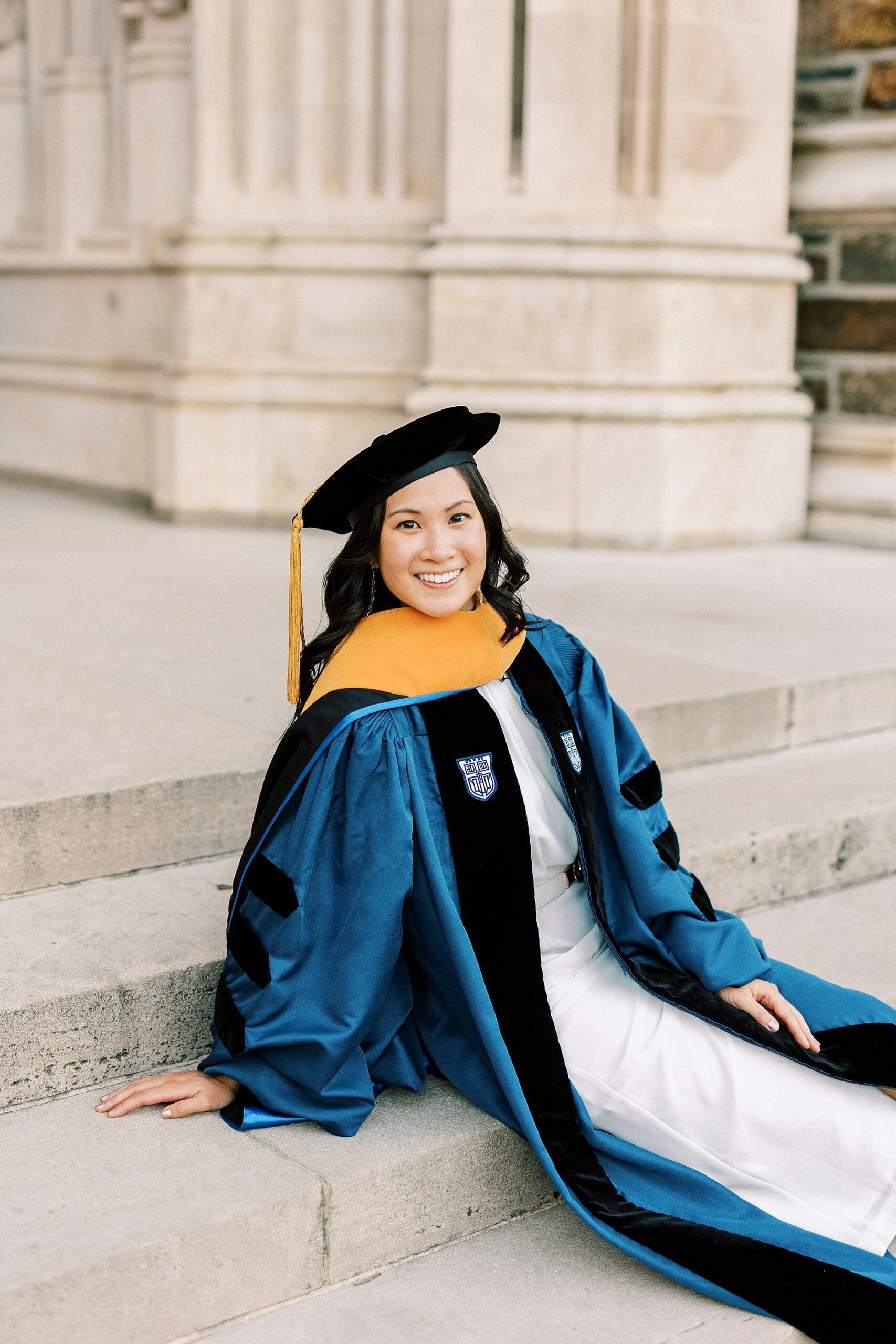 woman sits on steps of chapel at Duke University