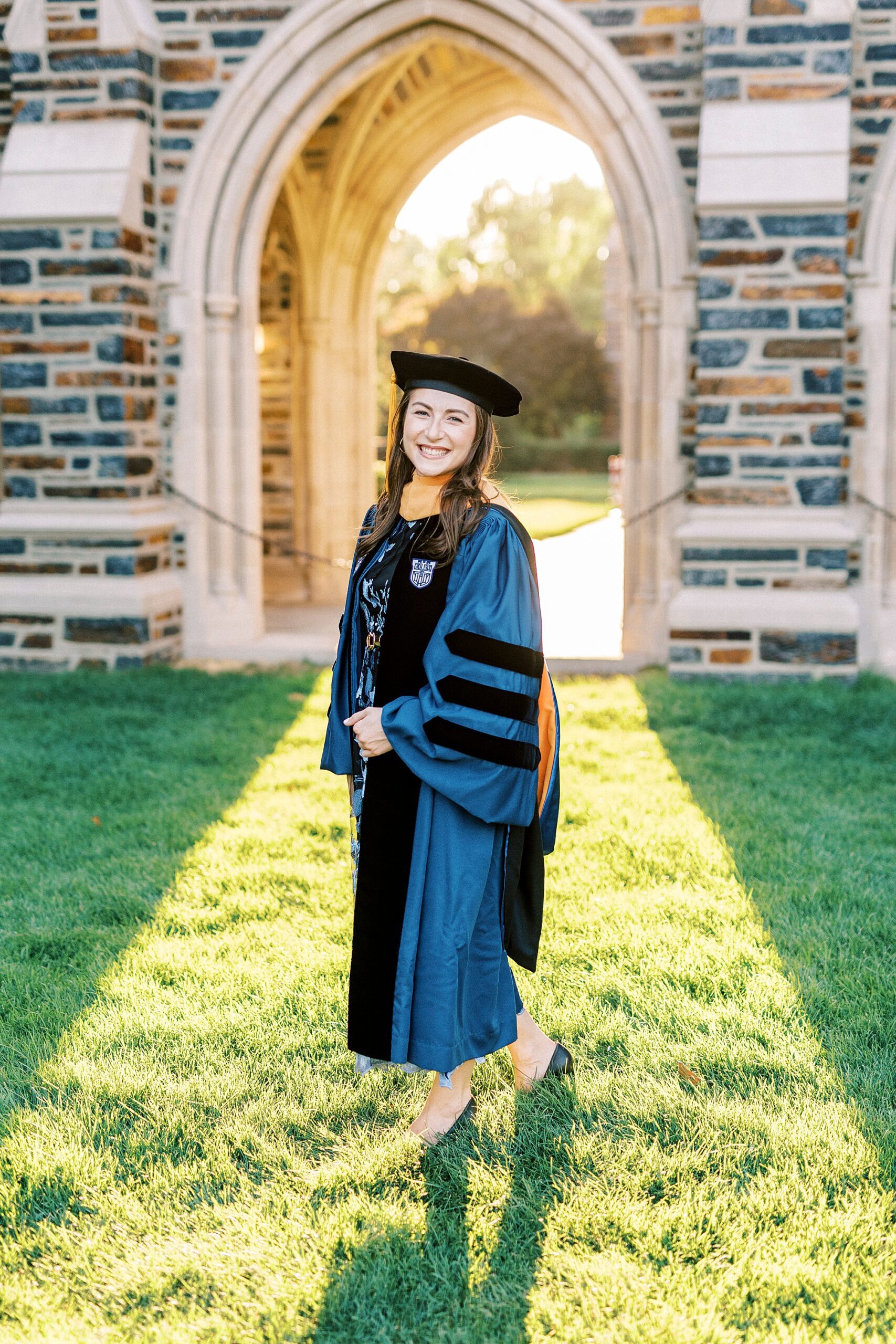 woman stands on lawn near chapel at Duke University