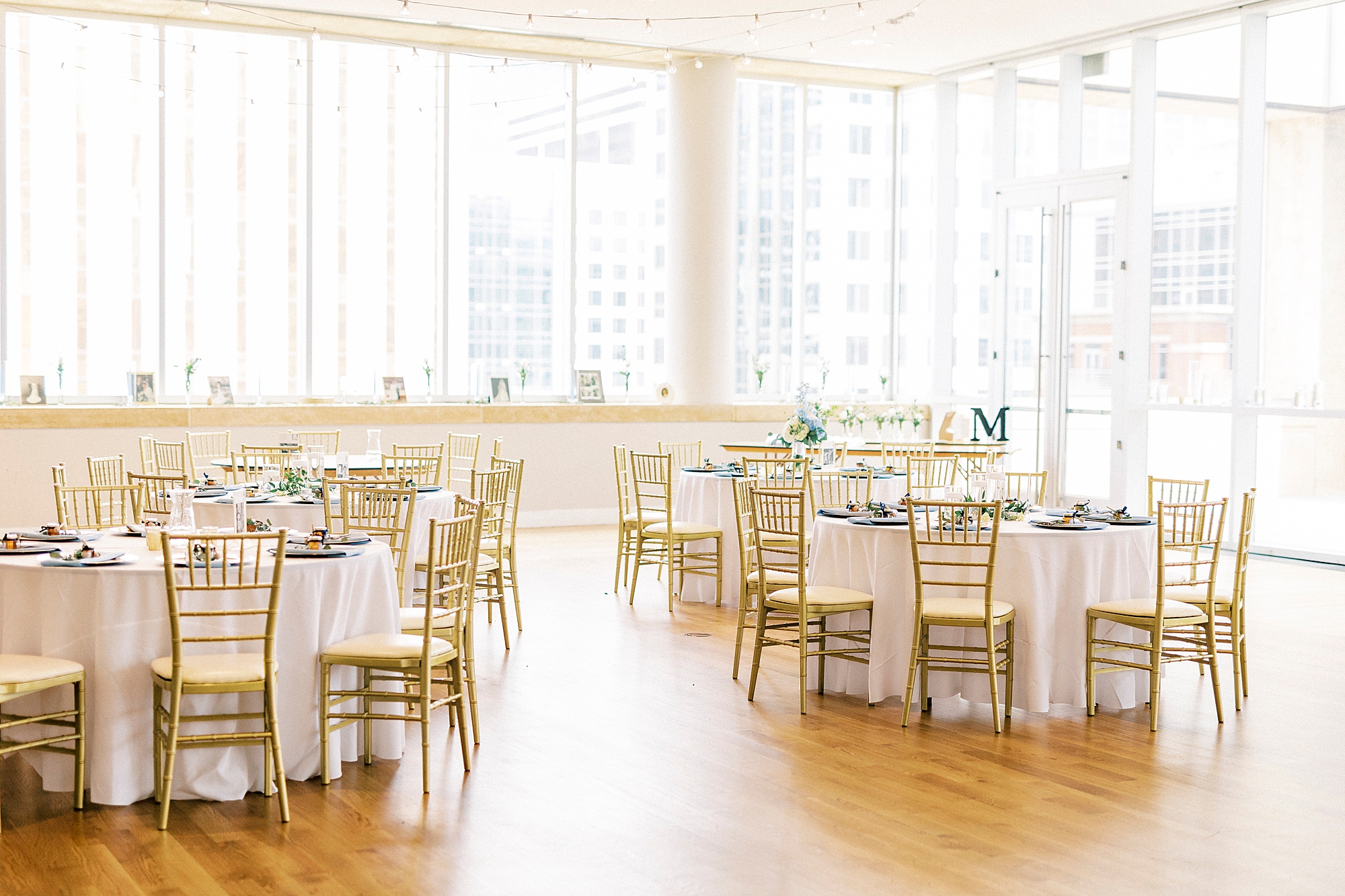 summer wedding reception with white, gold, and blue accents on tables