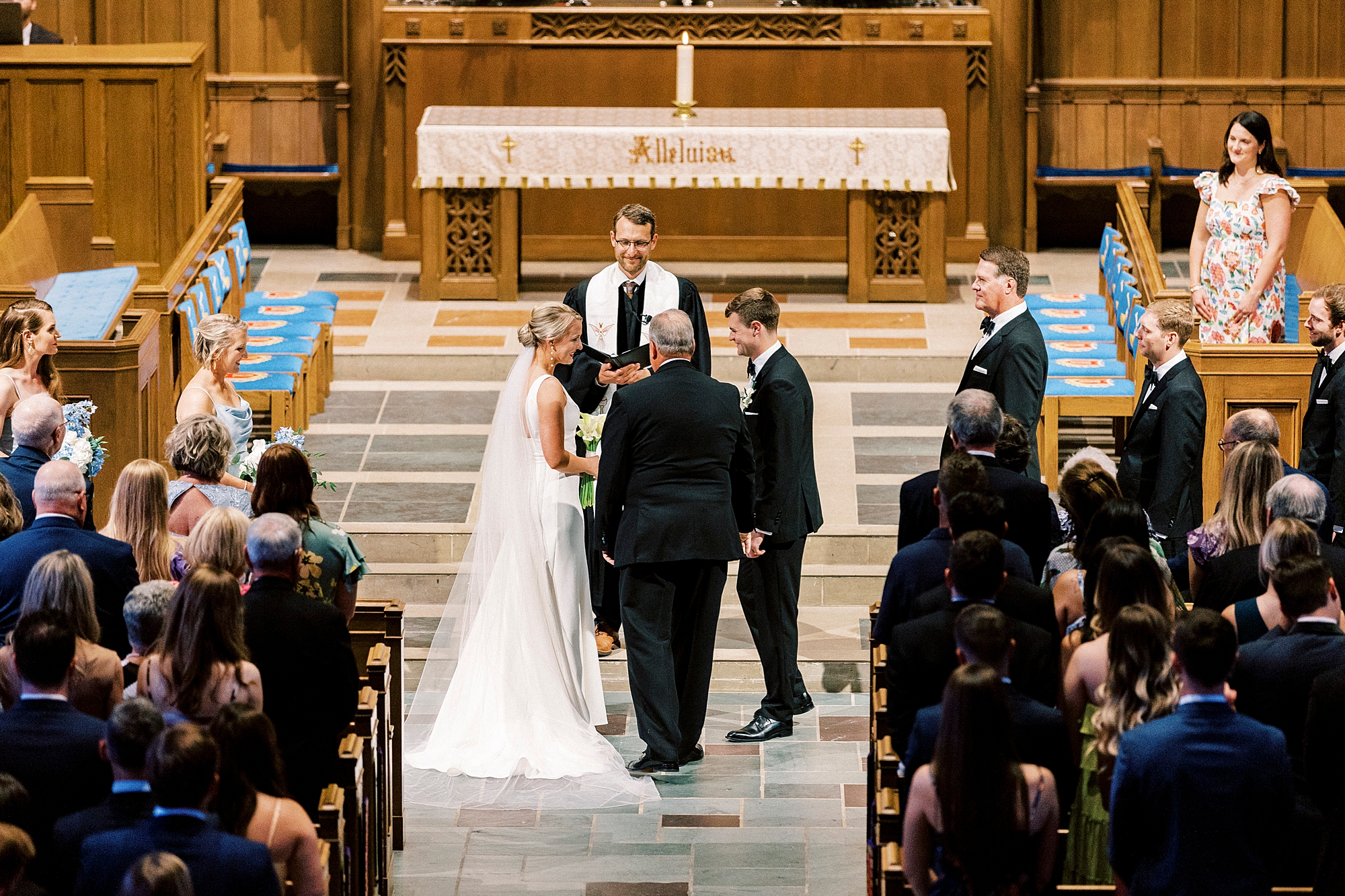 bride and groom hold hands during wedding ceremony