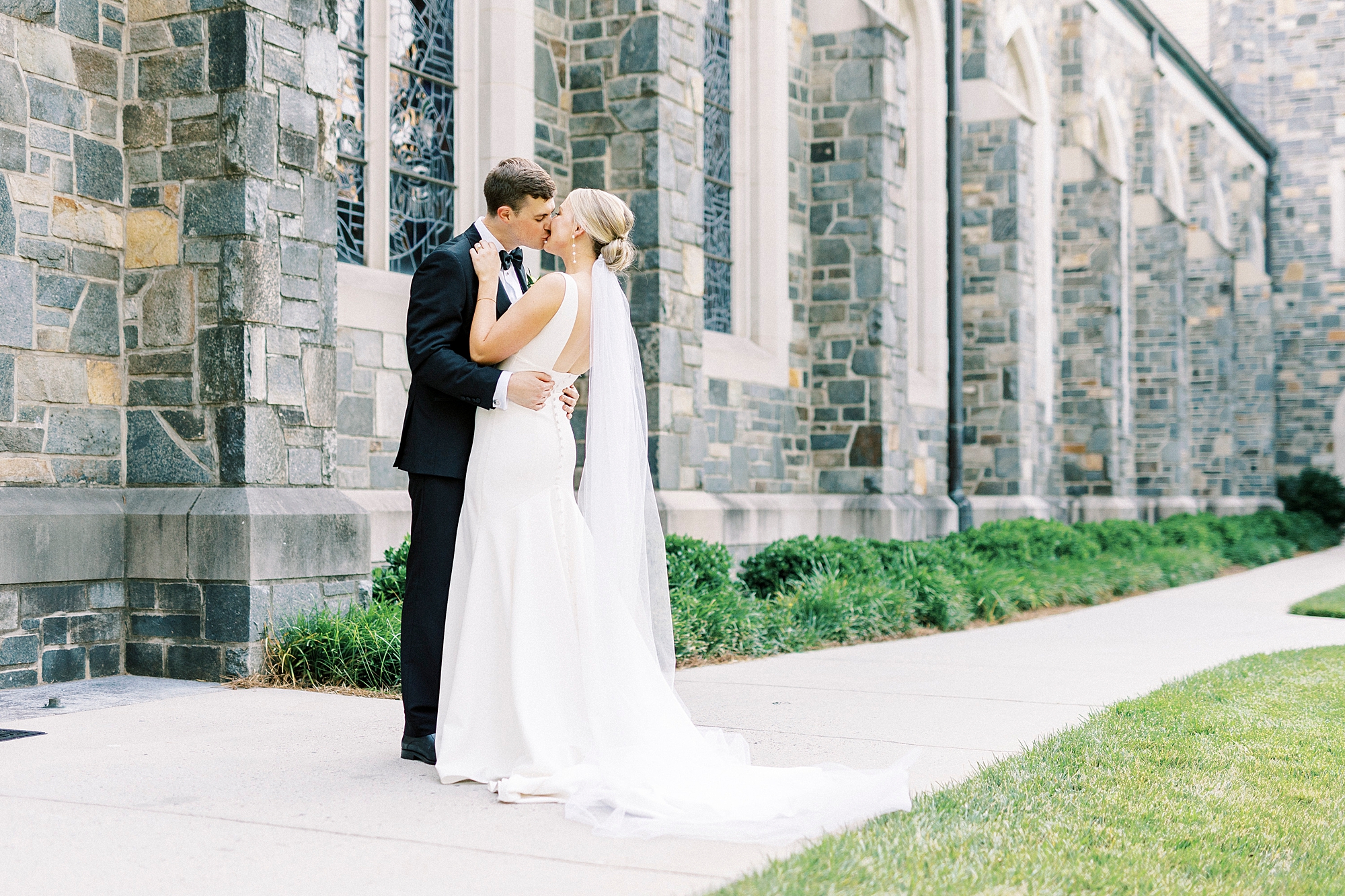 newlyweds kiss outside Myers Presbyterian Church on sidewalk