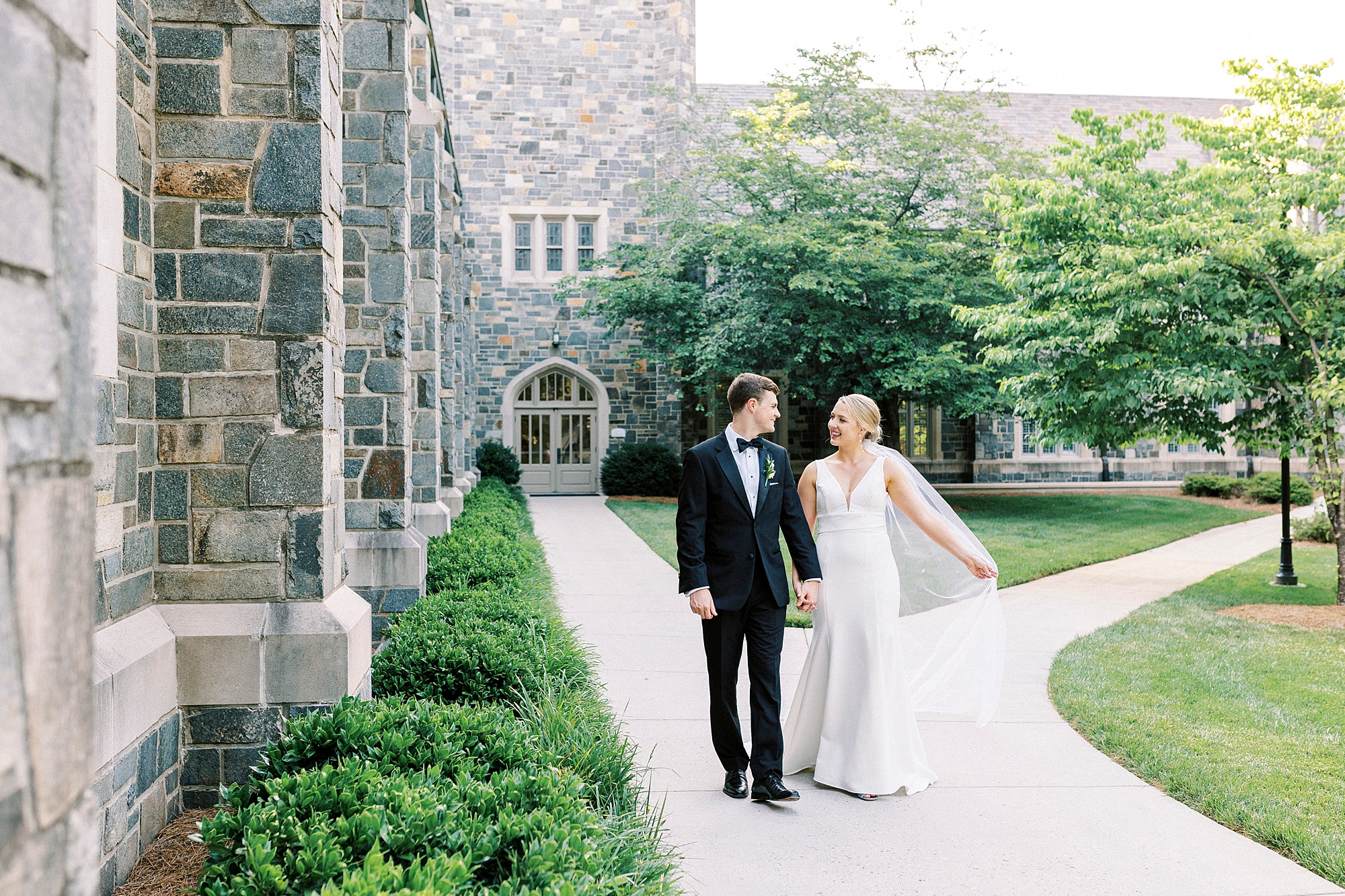 bride and groom walk outside Myers Presbyterian Church holding hands