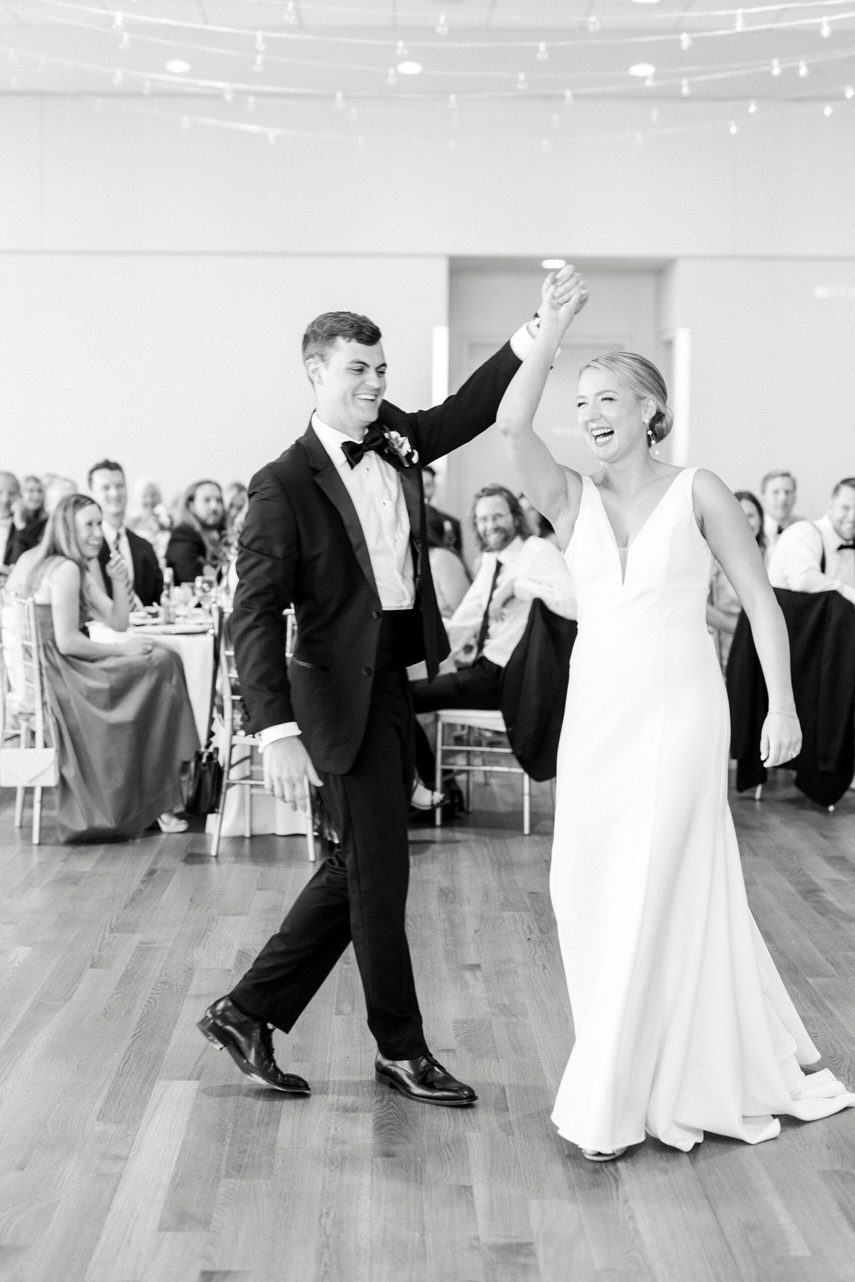 groom twirls bride during first dance at the Mint Museum Uptown