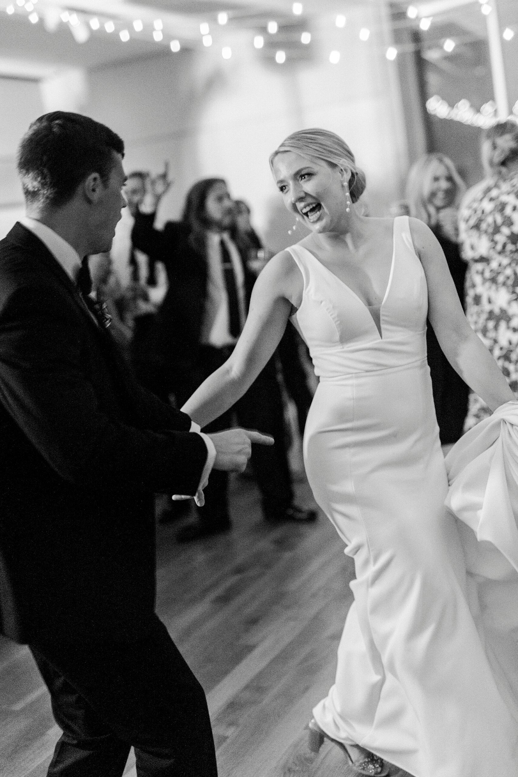 bride and groom dance together during reception at the Mint Museum Uptown