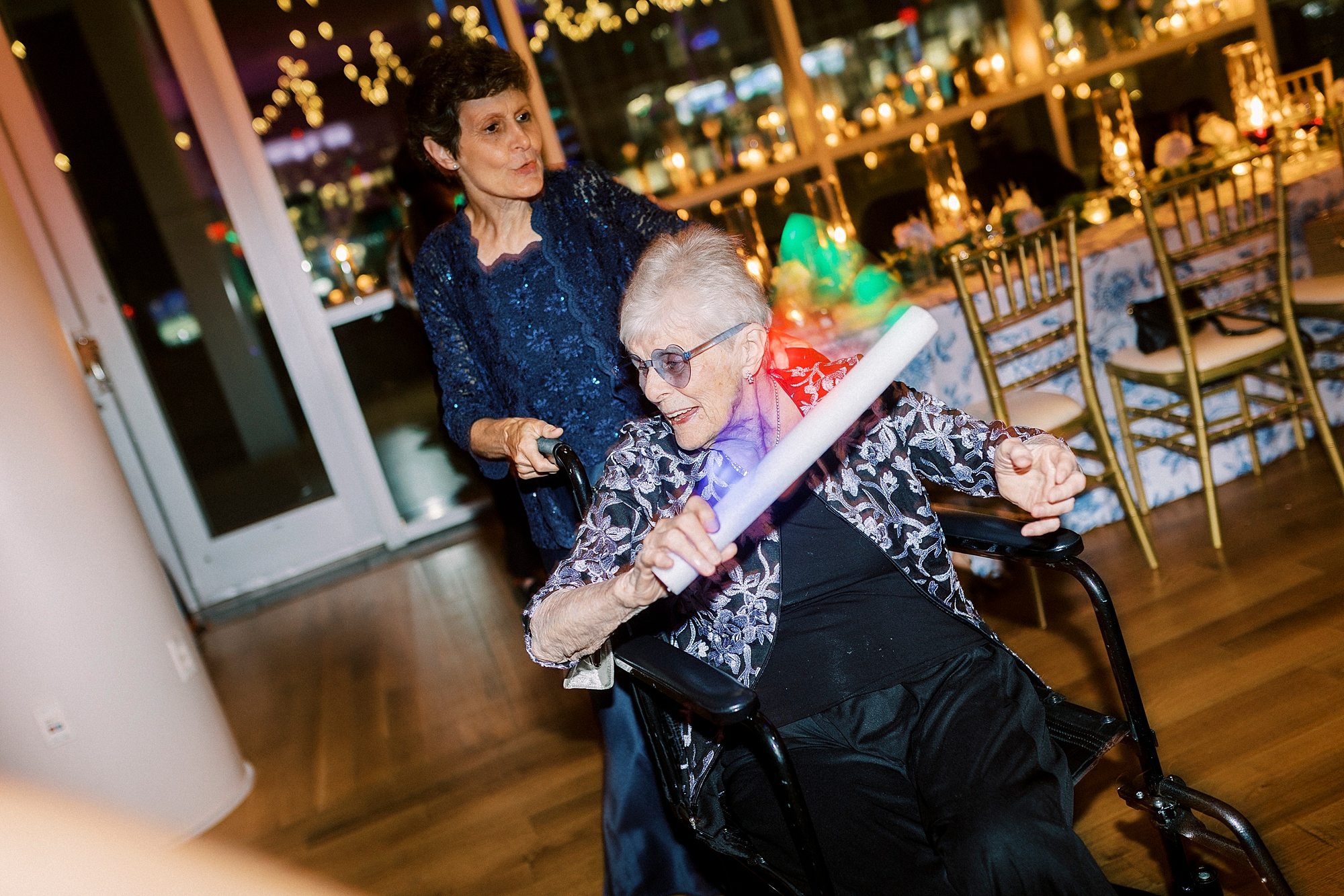 grandmother swings around glow stick at reception