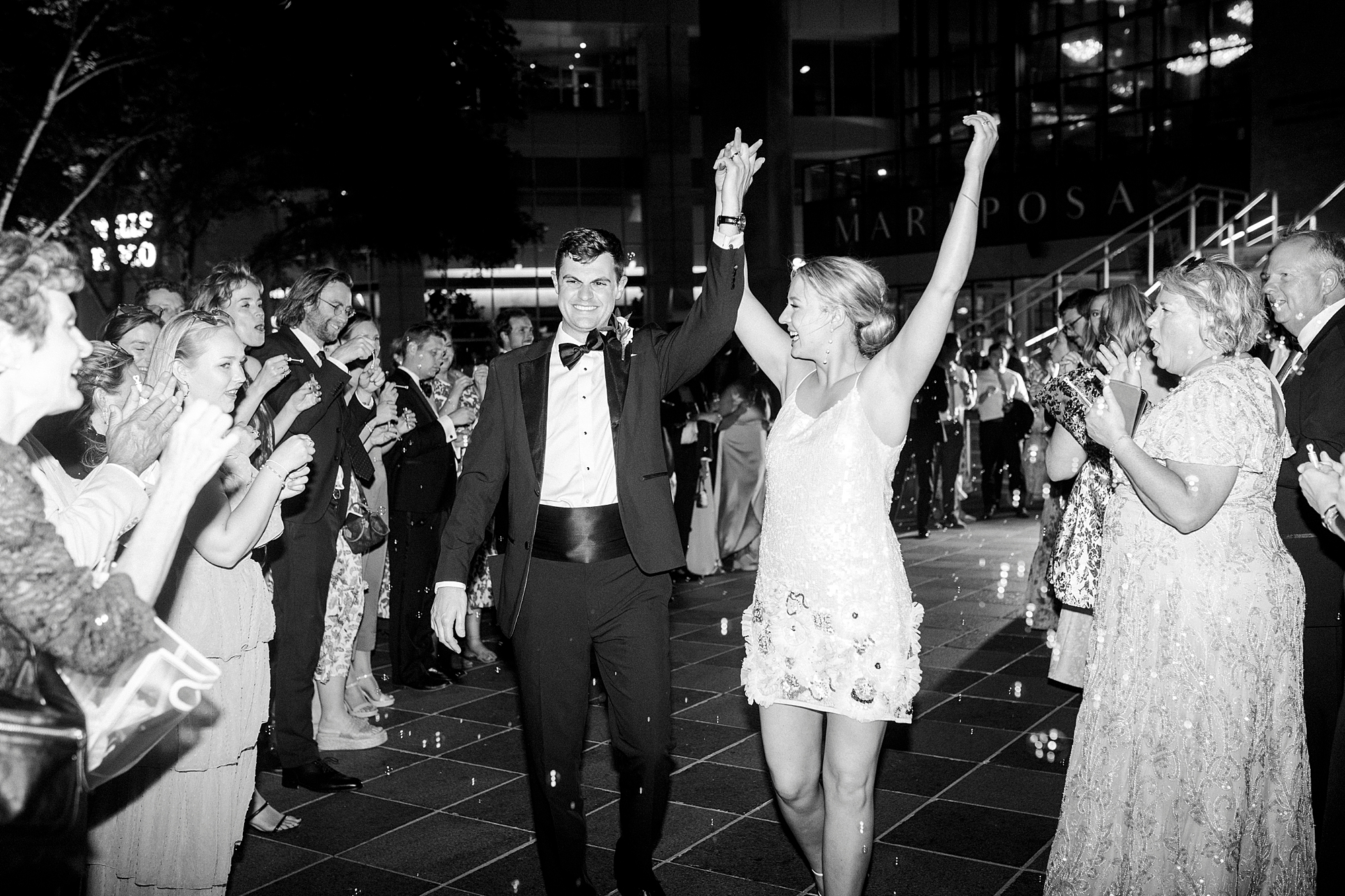 newlyweds cheer leaving reception at the Mint Museum Uptown