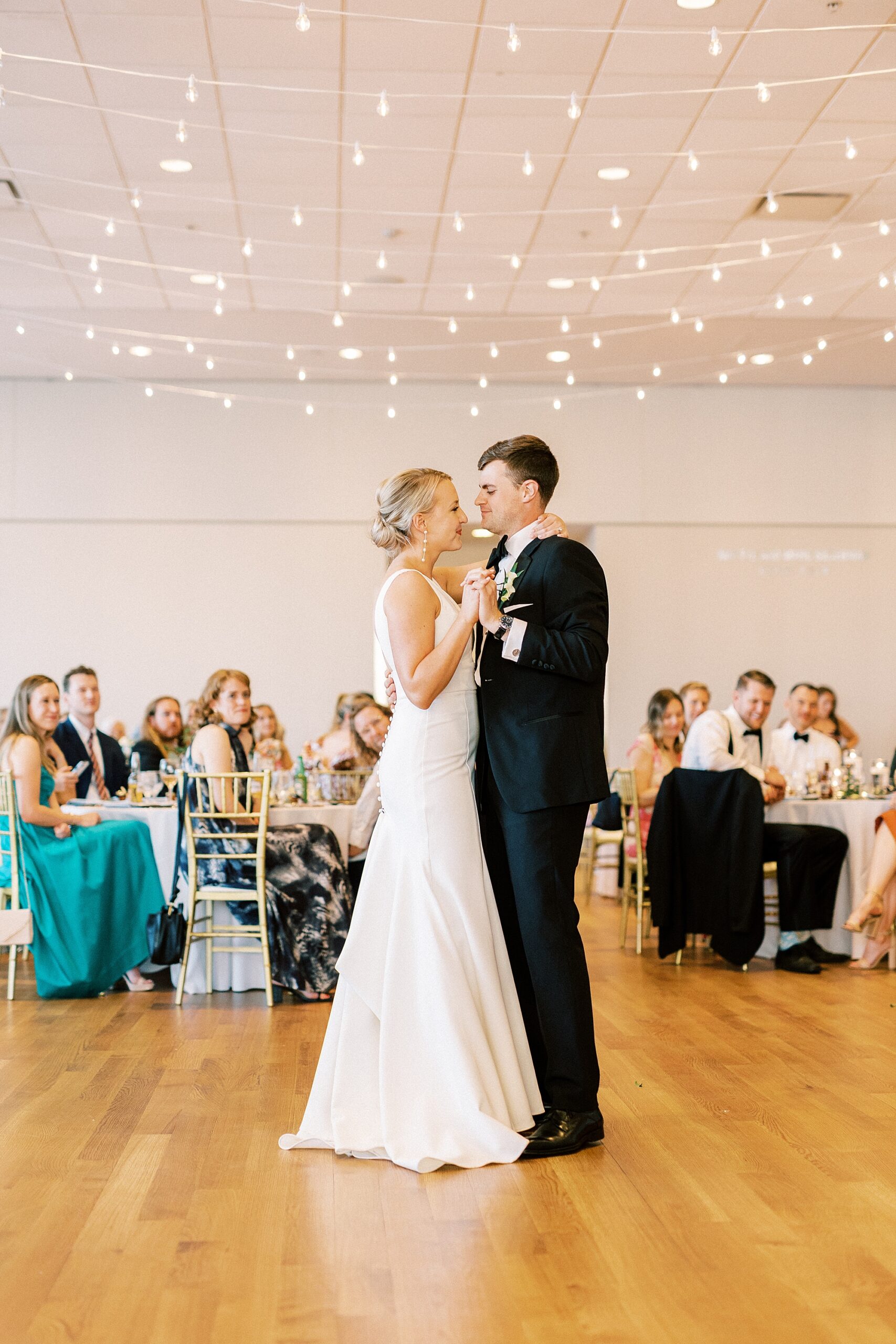 bride and groom dance during wedding reception at the Mint Museum Uptown