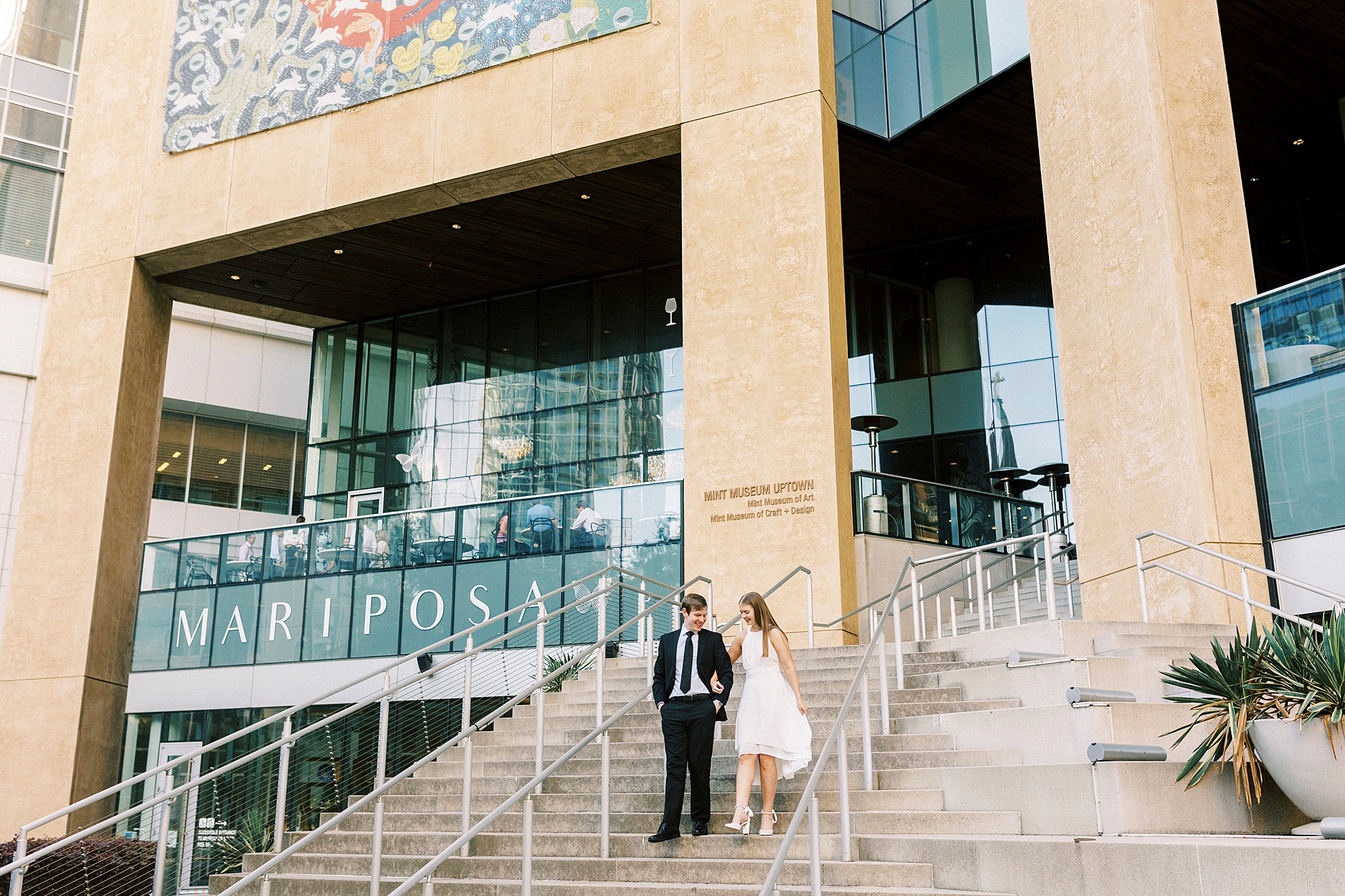 man and woman walk down steps at the Mint Museum in Charlotte NC