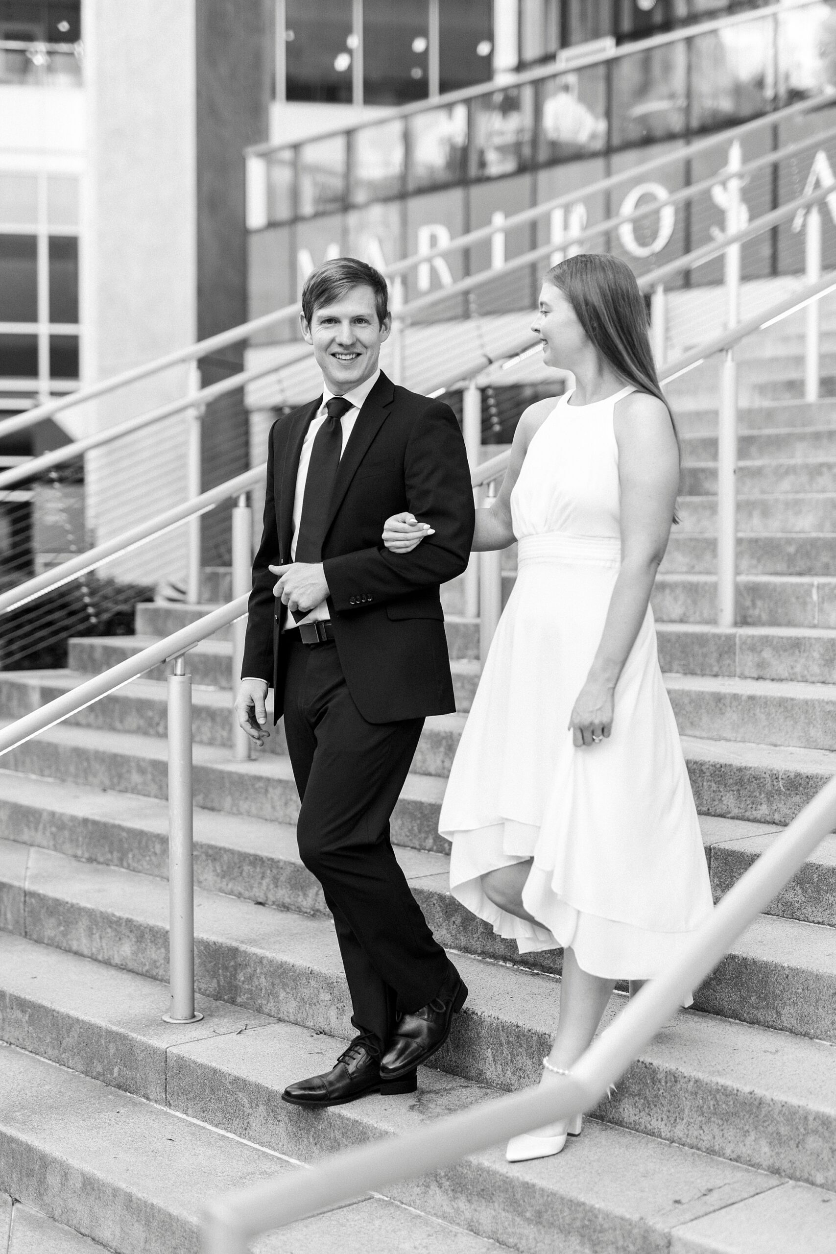 man escorts woman down steps of the Mint Museum in Charlotte NC