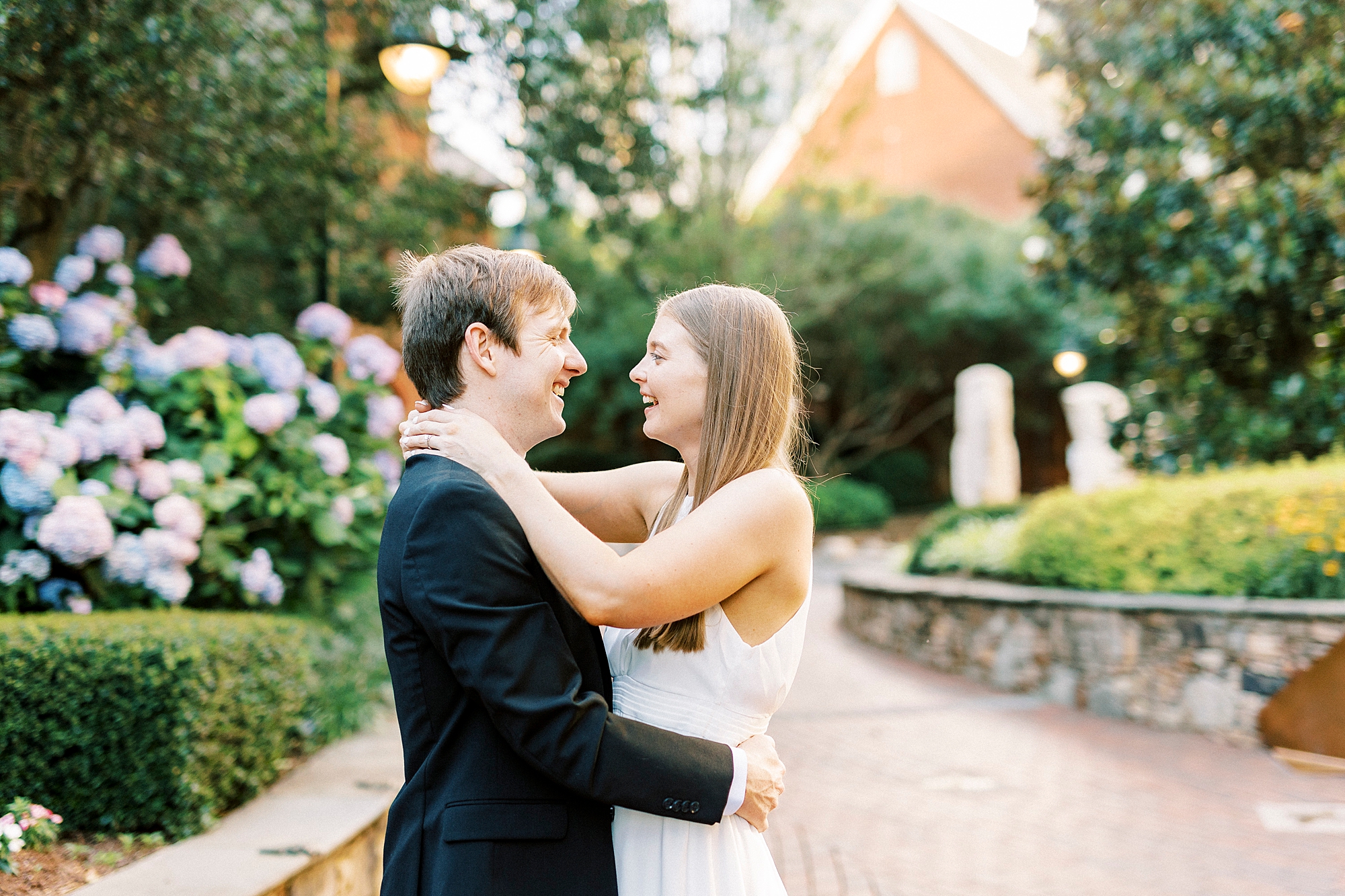 engaged couple hugs at sunset on path in Charlotte NC park