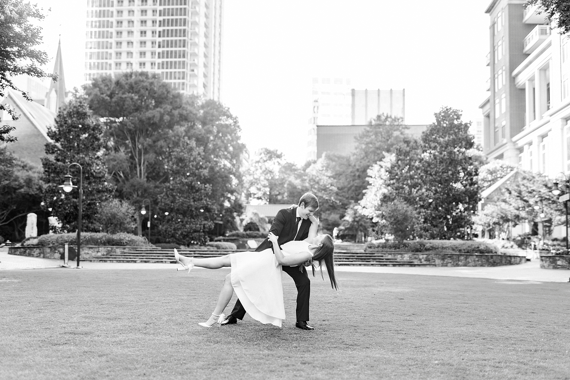 man dips woman on lawn of Charlotte green
