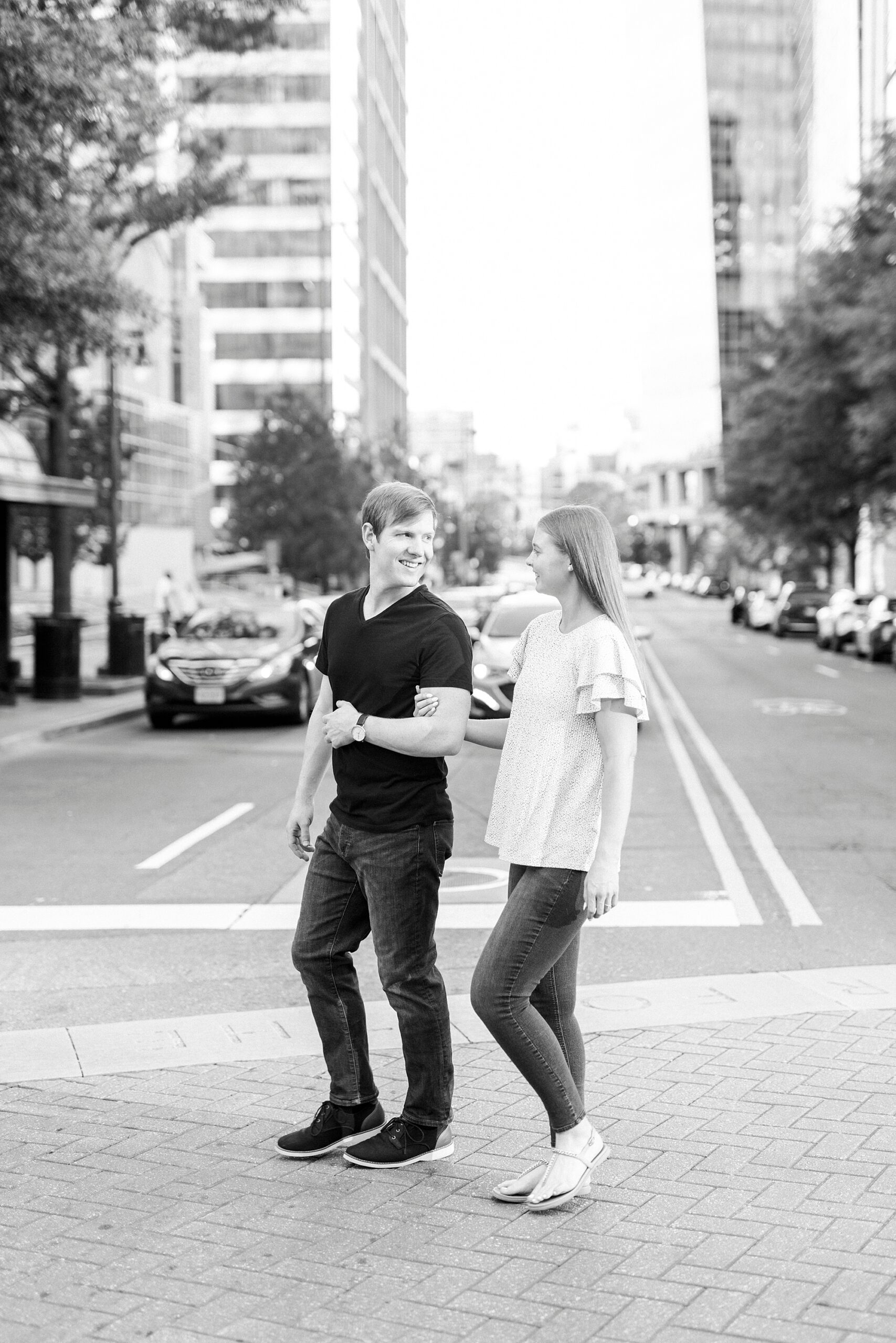 couple in casual outfits walk on street in Charlotte NC
