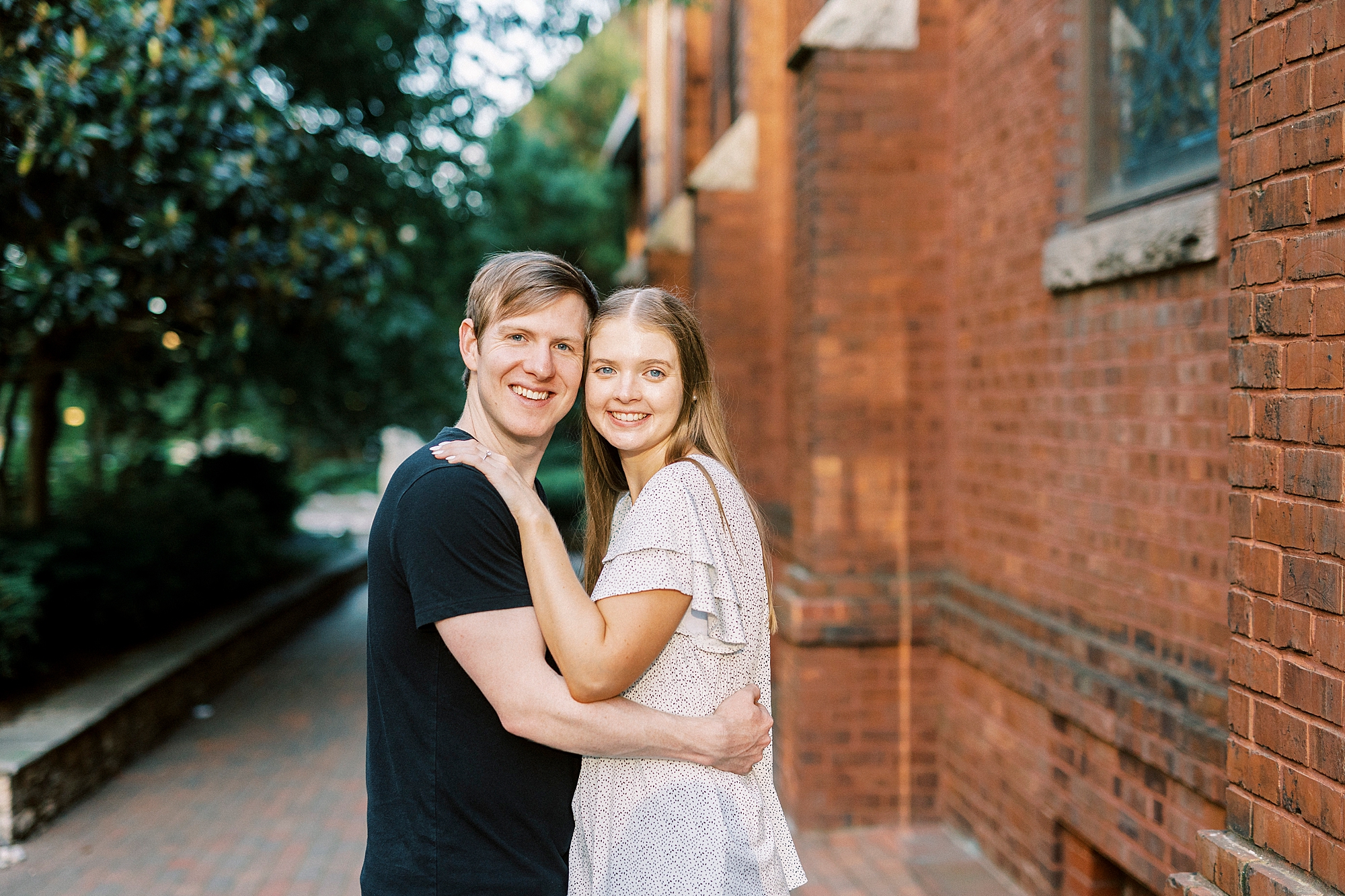 woman and man hug in Uptown Charlotte leaning heads together