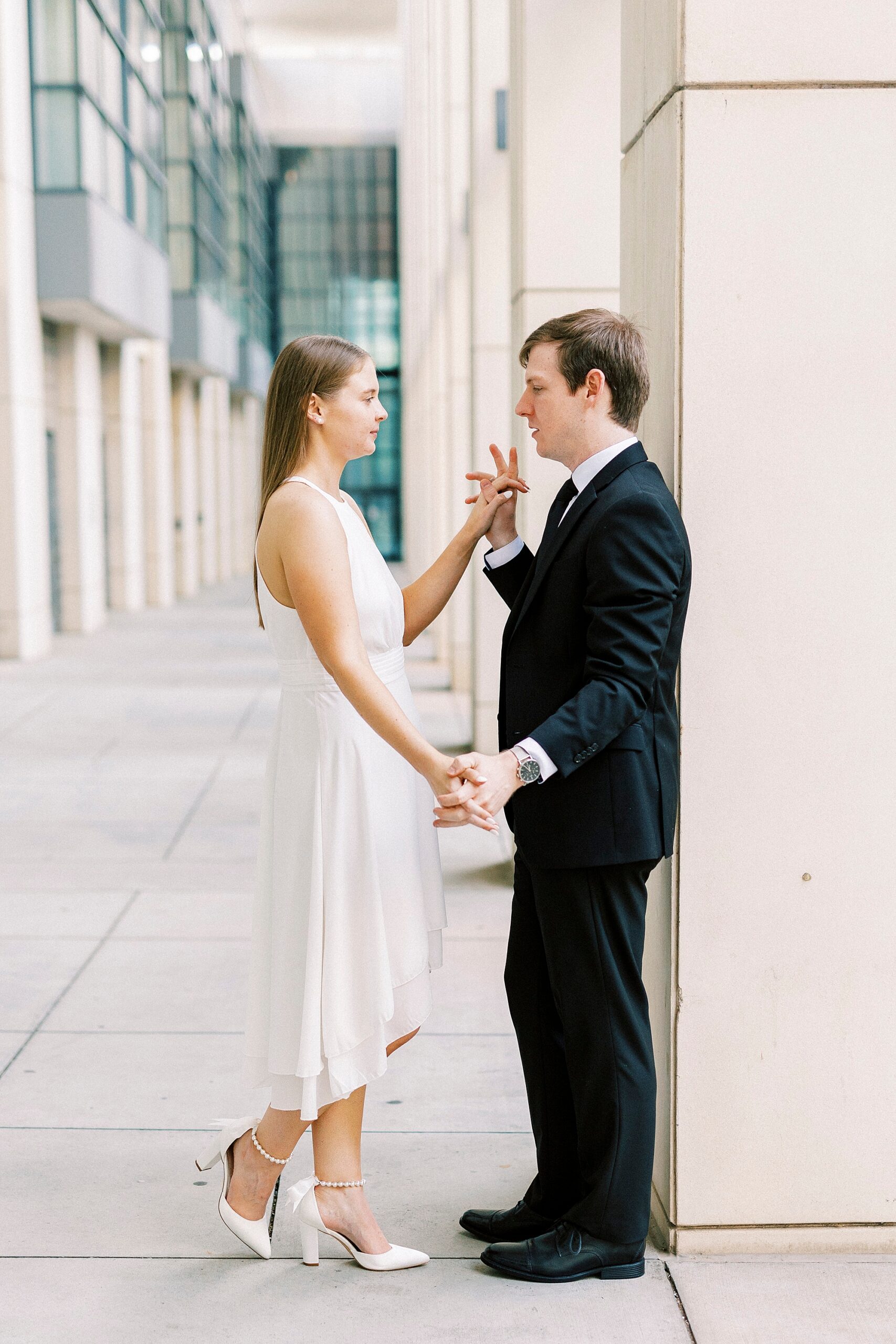 man and woman talk outside the Charlotte Convention Center holding hands