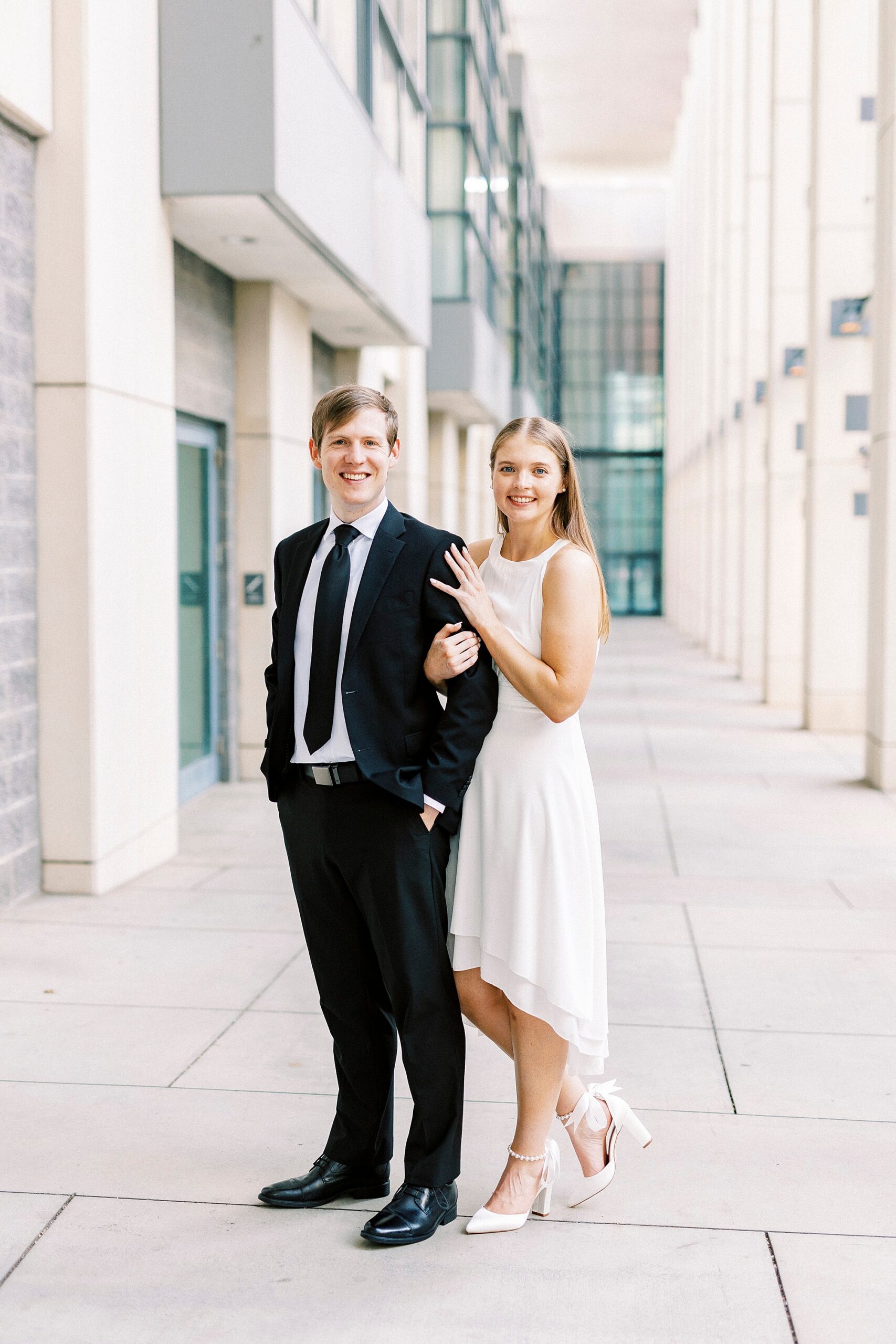 man and woman stand together in walkway of Charlotte Convention Center