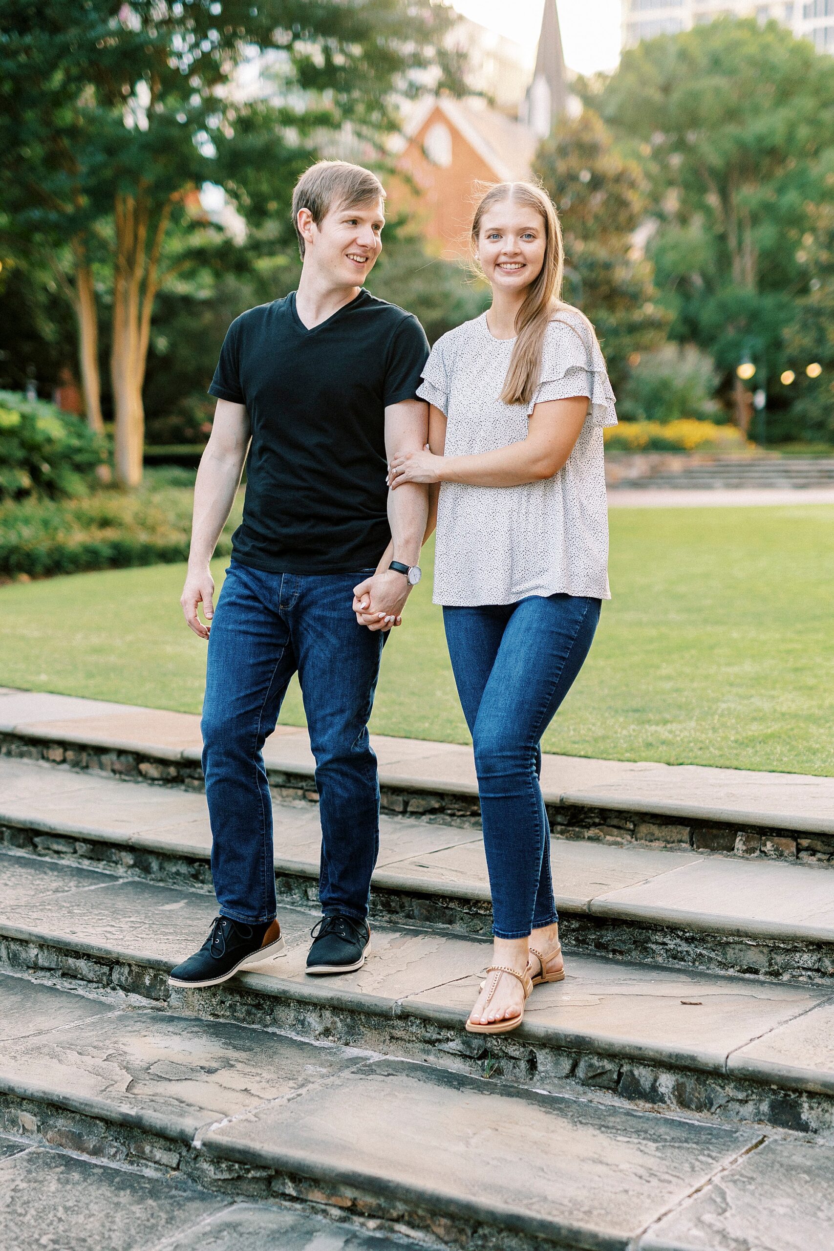 man and woman stand on stone steps in Charlotte NC park
