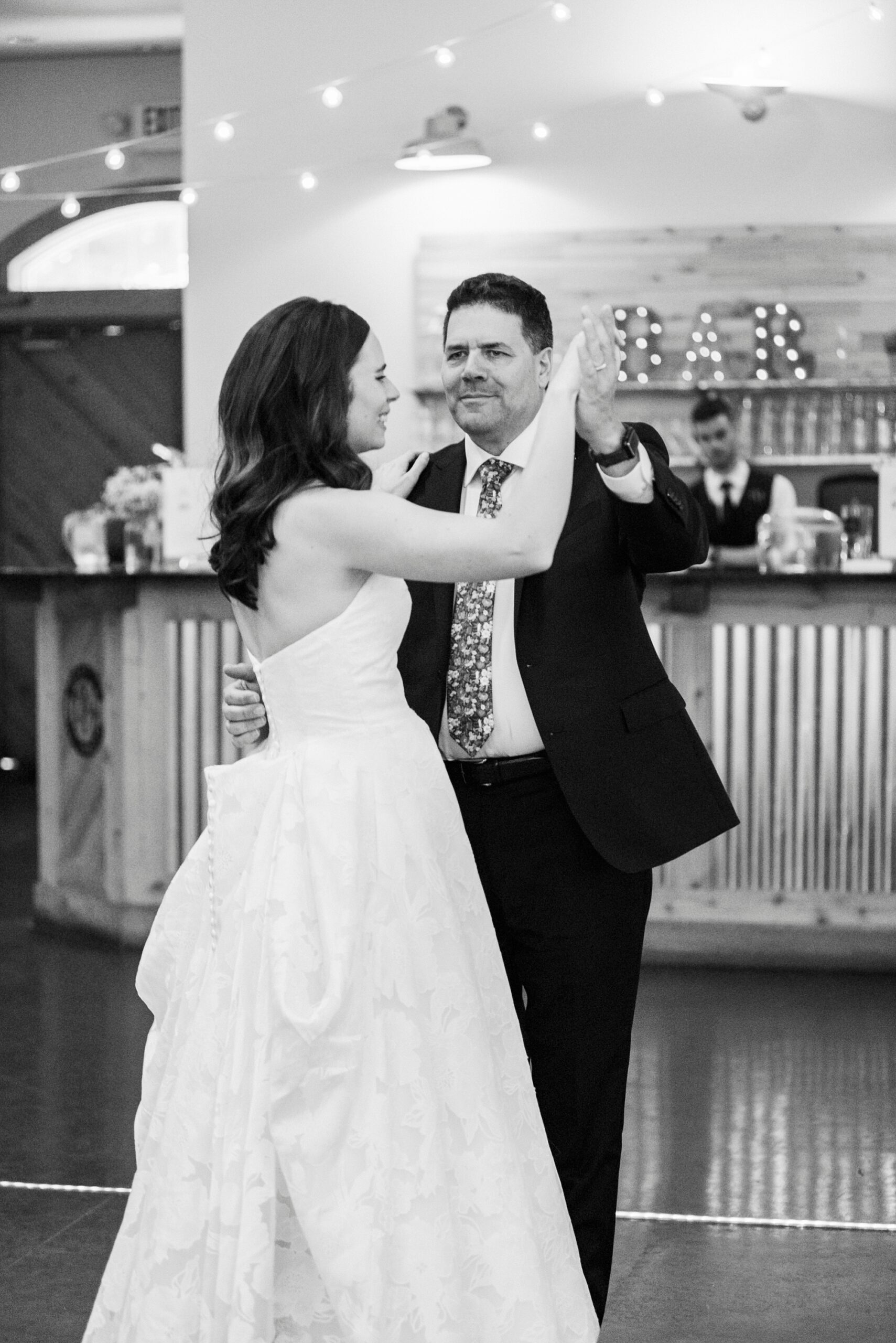 bride dances with father at reception in barn at Alexander Homestead