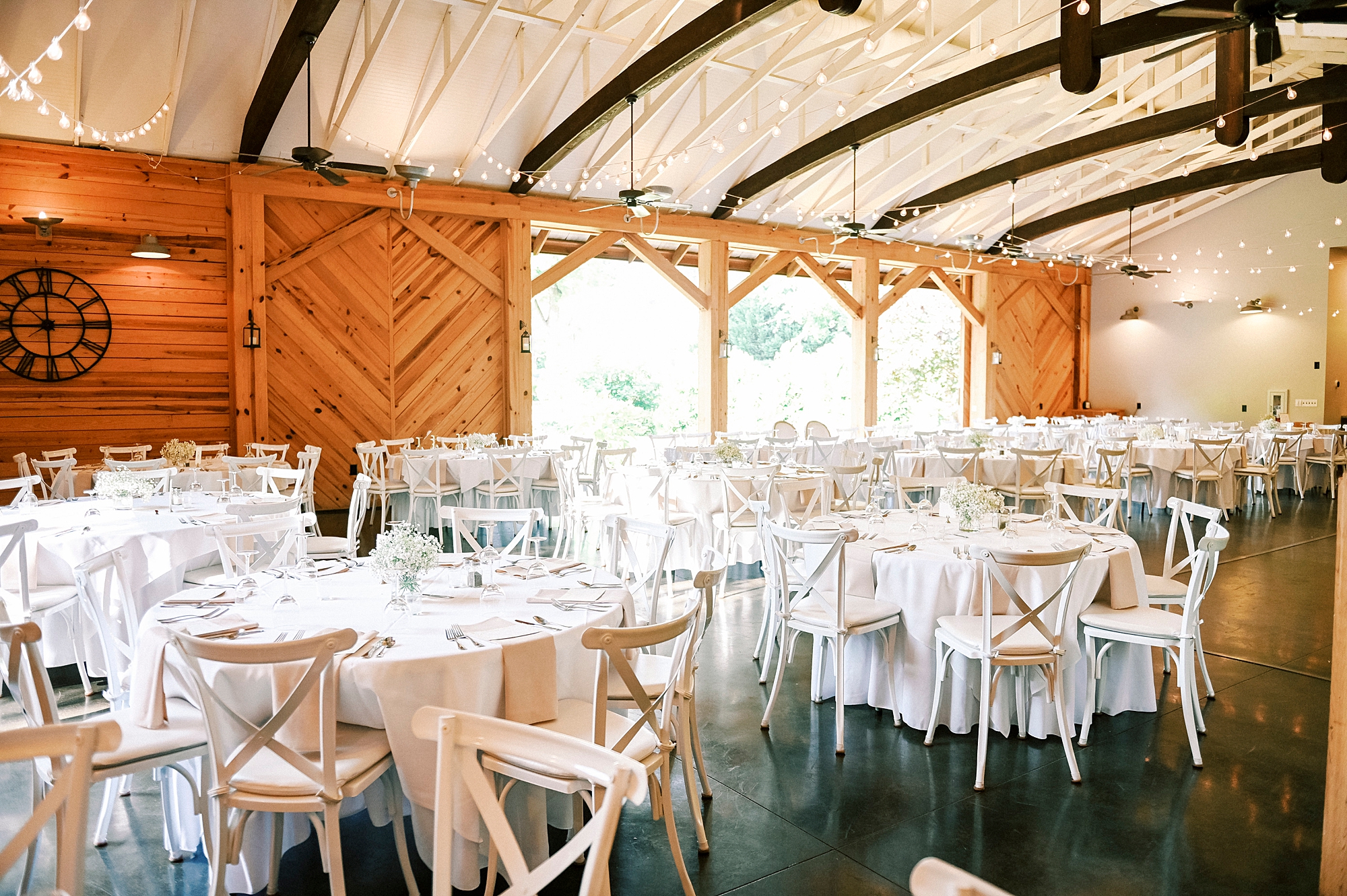 brunch wedding reception in barn at Alexander Homestead with white floral centerpieces