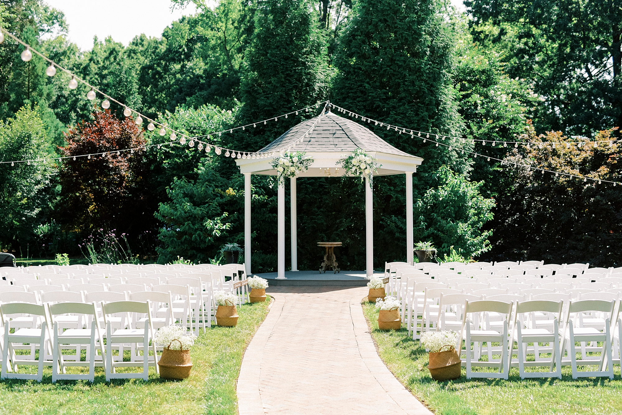 setup with white chairs for garden wedding ceremony at the gazebo at Alexander Homestead
