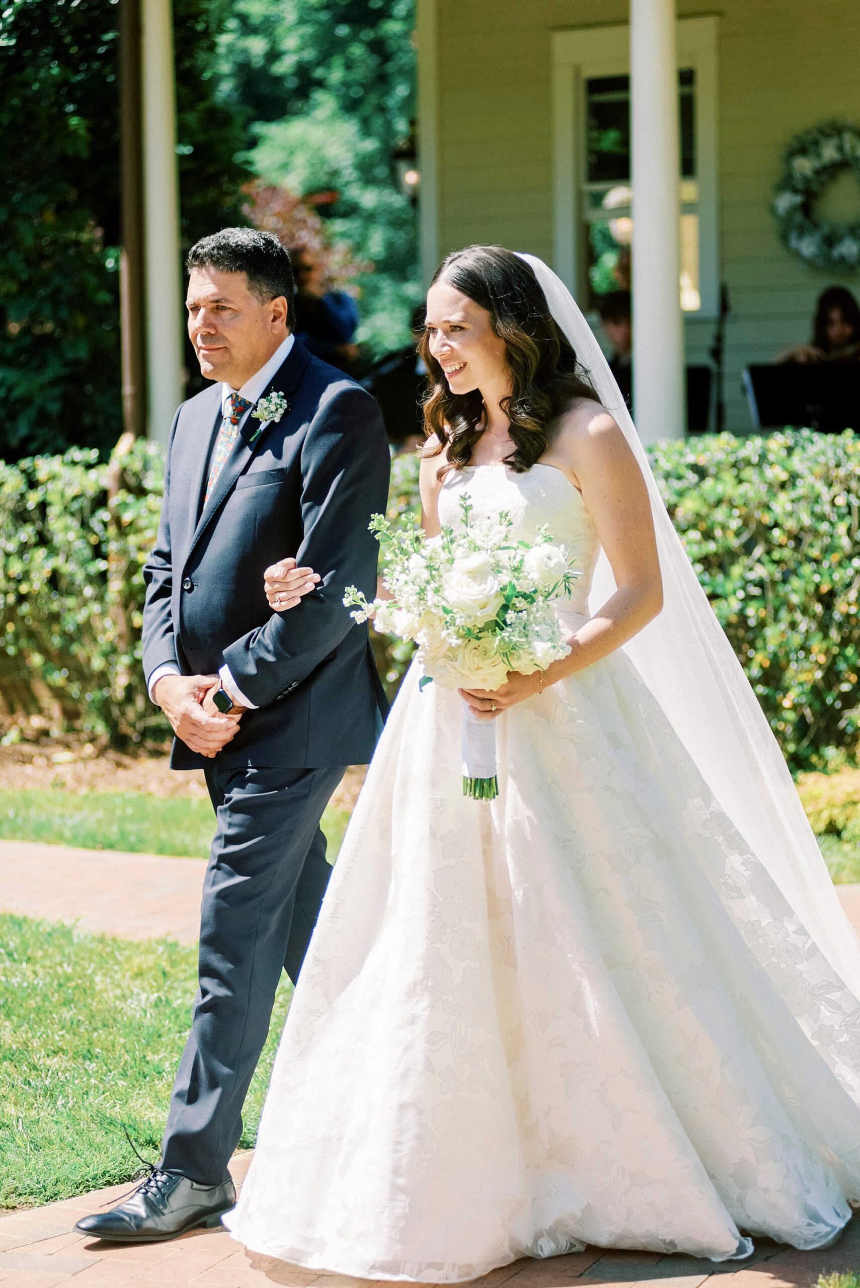 father escorts bride down aisle for ceremony in gardens of Alexander Homestead